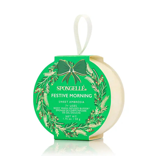 Spongellé Festive Morning Sweet Ambrosia body buffer ornament in green holiday wreath packaging on white background — Bliss by Cori Boutique