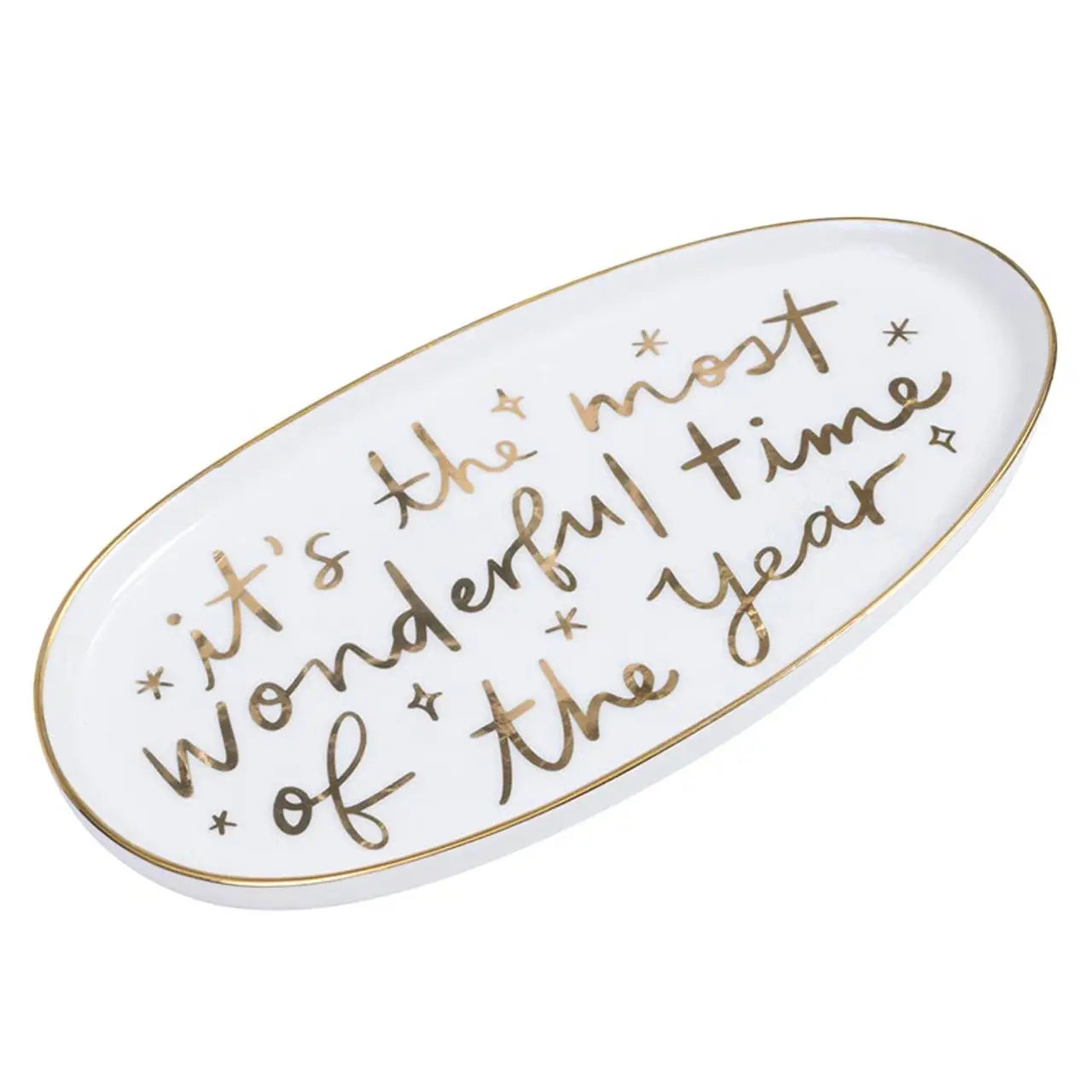 Angled view of white oval ceramic holiday platter with gold rim and gold foil 'It's the Most Wonderful Time of the Year' script lettering – Bliss by Cori