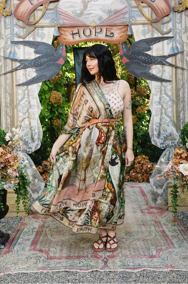 Model looking sideways with Book of Love scarf draped over one shoulder and belted over a printed maxi dress | Bliss by Cori