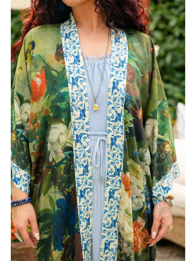 Close-up of the botanical flower, bird, butterfly, and vine print on Flora Poetica duster | Bliss by Cori