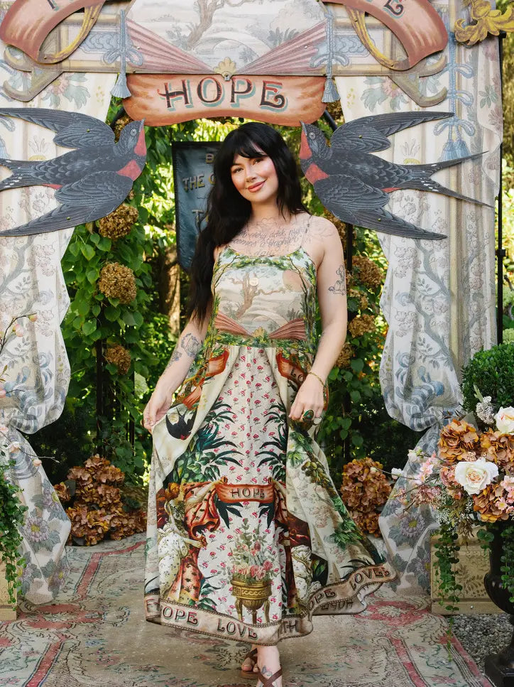 Model wearing Book of Love maxi slip dress with landscape bodice, swallow motifs, and flowing printed skirt | Bliss by Cori