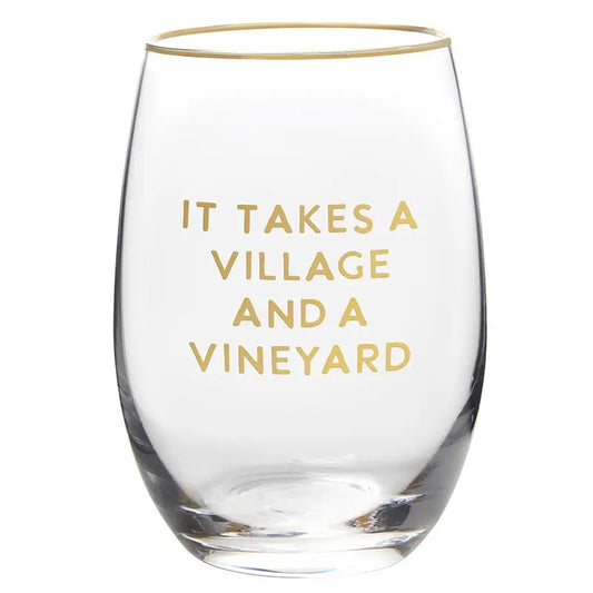 Clear stemless wine glass with gold rim and gold foil It Takes a Village and a Vineyard block text lettering on white background – Bliss by Cori
