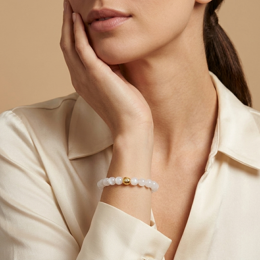 Karma and Luck Moonlit Dreams Moonstone Evil Eye Bracelet worn on wrist — milky white moonstone beads with pearl-toned gold evil eye charm, lifestyle shot | Bliss by Cori