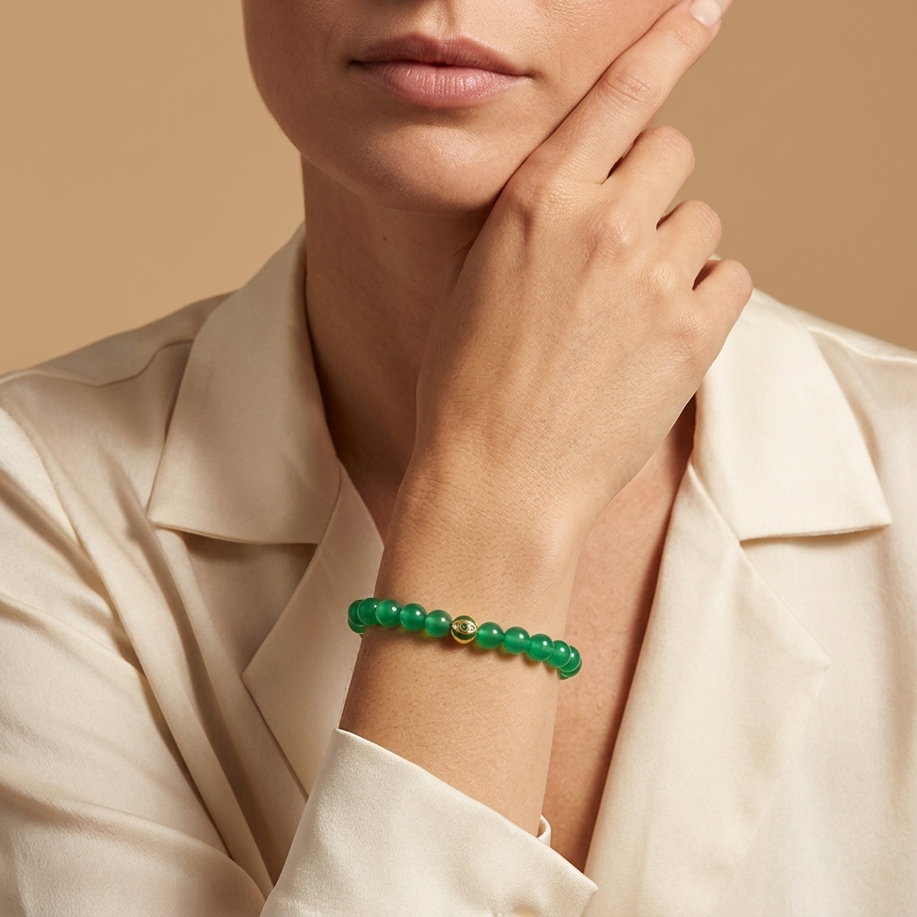 Karma and Luck Lucky Bloom Emerald Evil Eye Bracelet worn on wrist — vivid emerald green agate beads with green and gold evil eye charm, lifestyle shot | Bliss by Cori