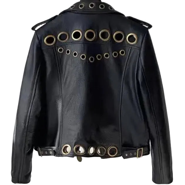 Flat lay front detail of black lambskin leather moto jacket showing asymmetrical lapel collar, oversized hollow metal ring embellishments, dual zipper pockets, and gold coin hardware on white background — Bliss by Cori