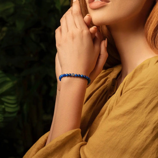 Karma and Luck Wise Guidance Lapis Evil Eye Bracelet worn on wrist — deep blue lapis lazuli beads with gold evil eye charm | Bliss by Cori