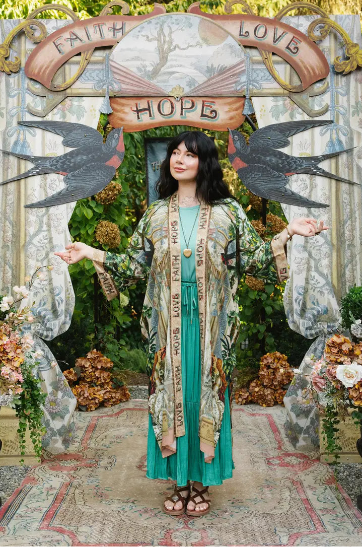 Full-length view of Book of Love duster worn open over a turquoise dress with arms extended | Bliss by Cori