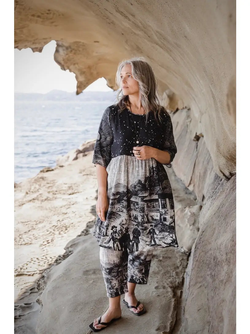Stargazer Artist Dress styled as long tunic over matching celestial print pants, worn in sandstone cave with ocean view | Bliss by Cori Boutique