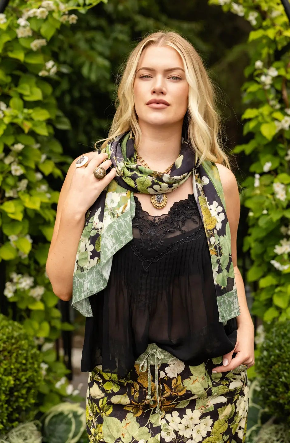 Front view of the Equinox bohemian scarf draped over a black top in a leafy garden | Bliss by Cori