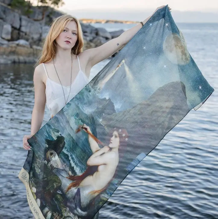 Model holding open the Market of Stars Siren scarf to show its mermaid, moon and ocean artwork | Bliss by Cori