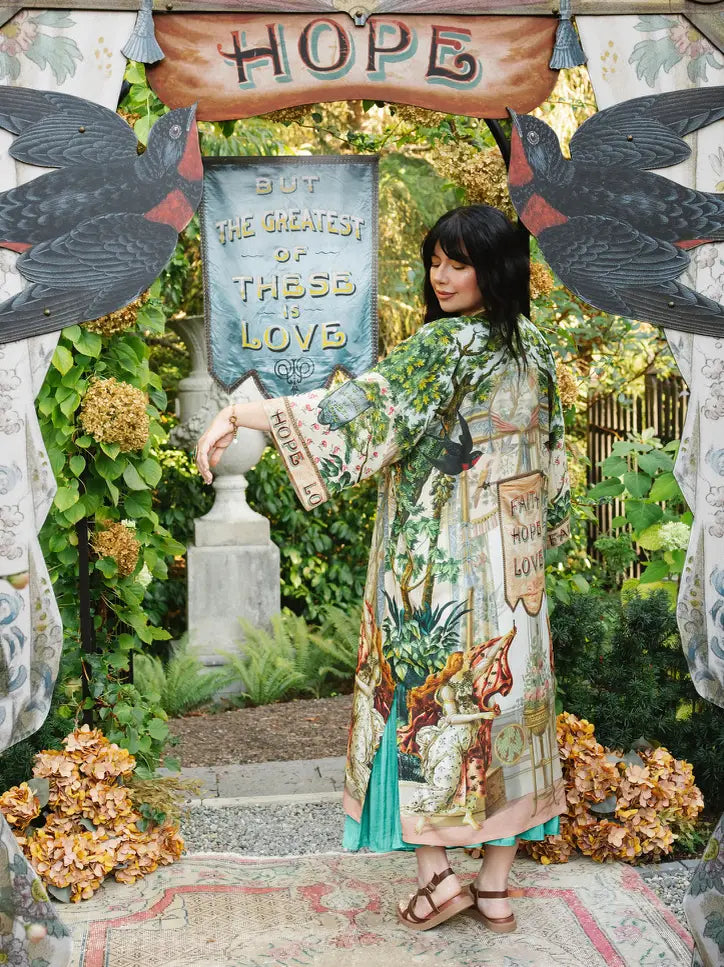  Angled back view of Book of Love duster showing its Faith Hope Love banner, swallow, and garden artwork | Bliss by Cori