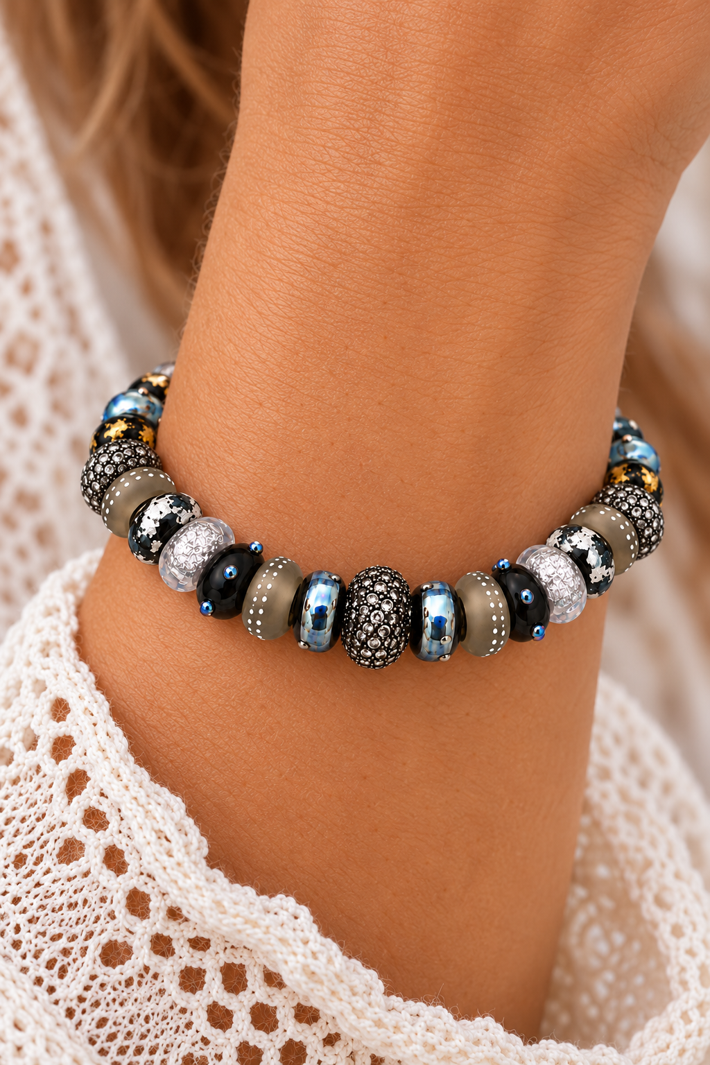 Silver Smoke bracelet worn on a wrist, featuring patterned black and smoky gray beads, reflective silver-blue accents and a sparkling center bead | Bliss by Cori