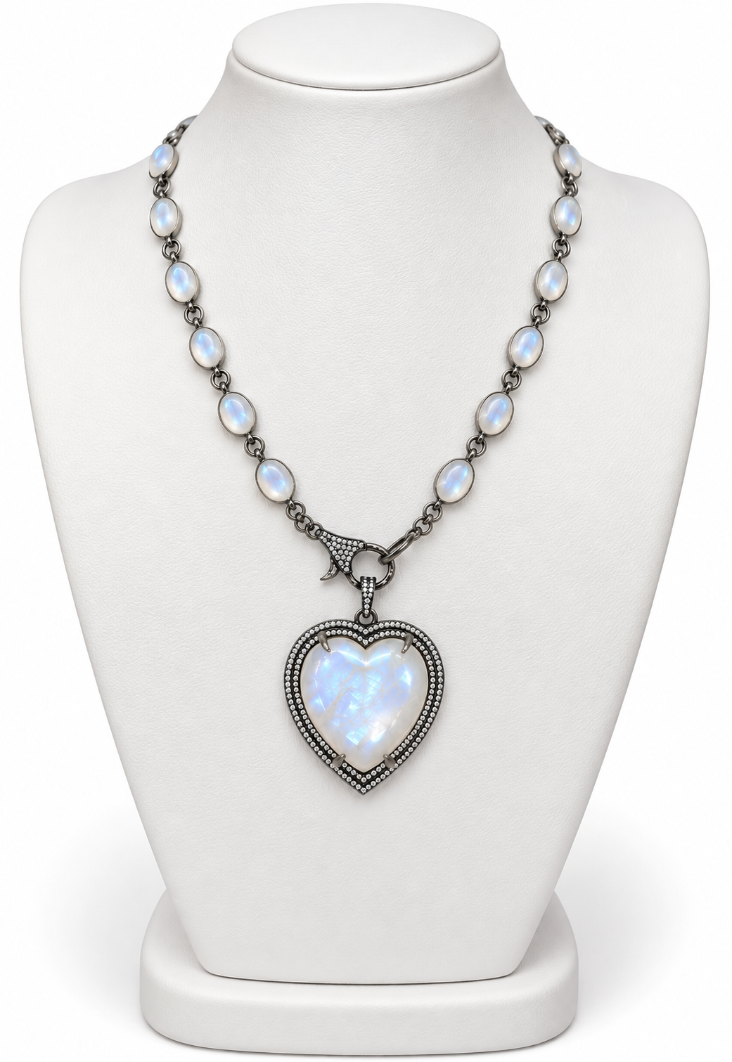 Genuine moonstone and diamond heart necklace in sterling silver displayed on a white jewelry stand | Bliss by Cori