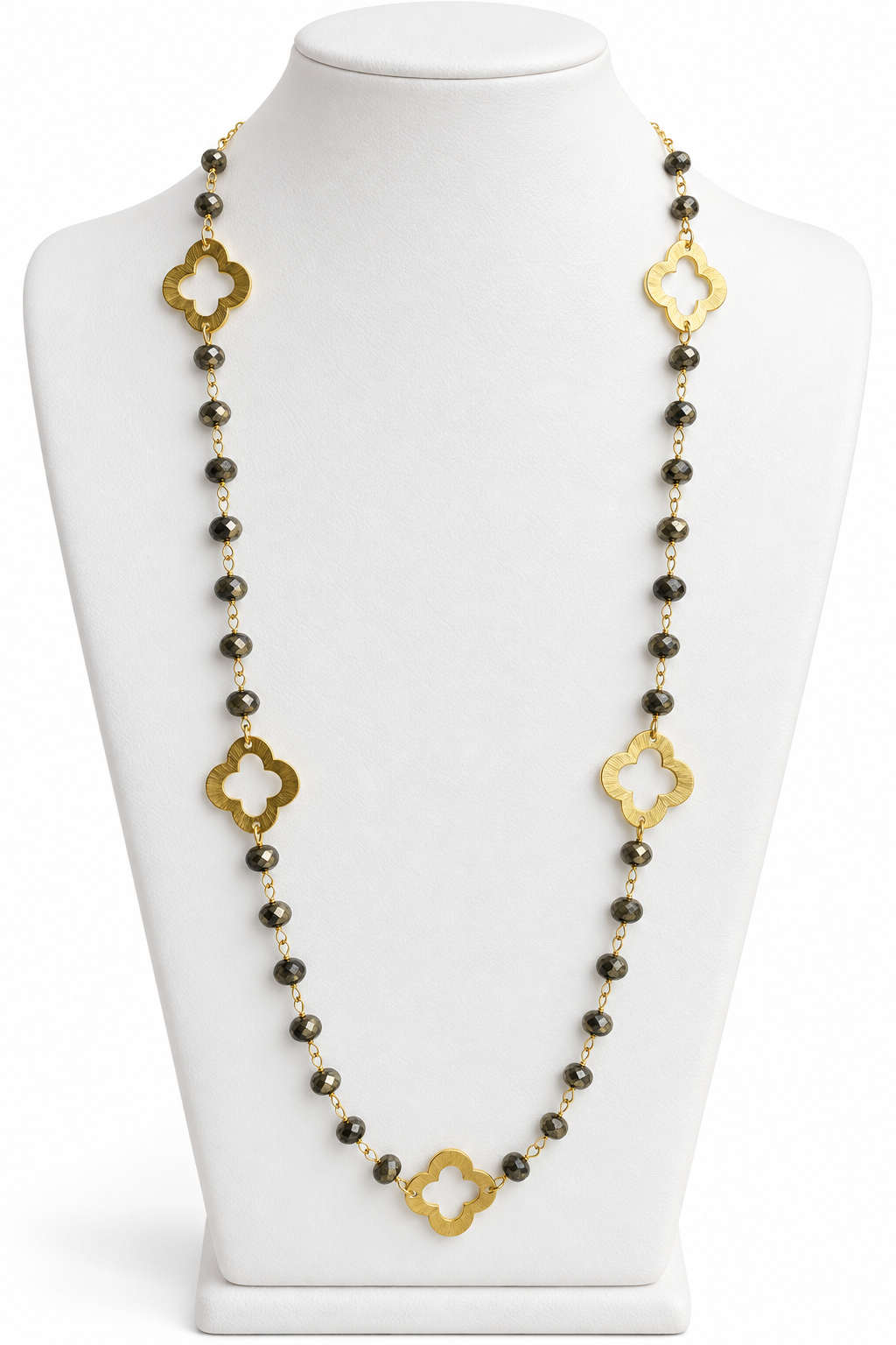 Pyrite faceted bead necklace with gold open quatrefoil clover accents displayed on a white jewelry bust | Bliss by Cori