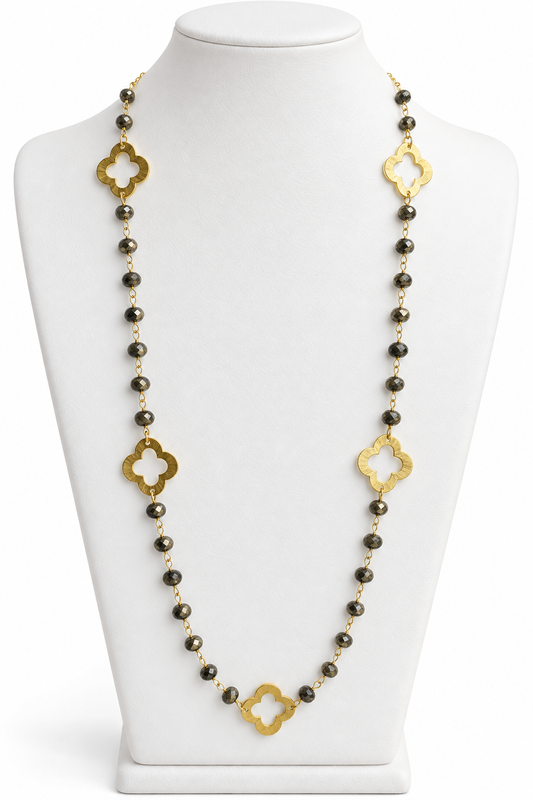 Pyrite faceted bead necklace with gold open quatrefoil clover accents displayed on a white jewelry bust | Bliss by Cori