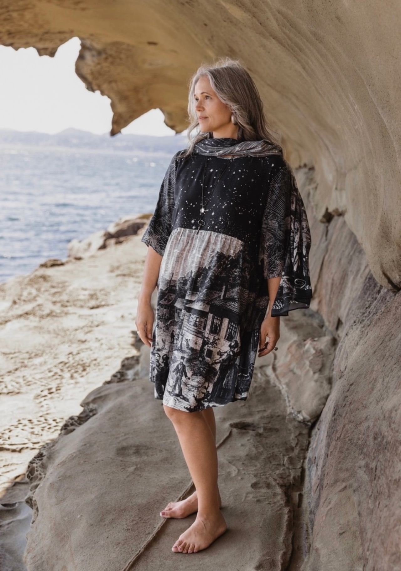 Stargazer Artist Dress with celestial print, front view showing star field bodice and Leonid meteor shower village scene skirt — boho shift dress | Bliss by Cori Boutique