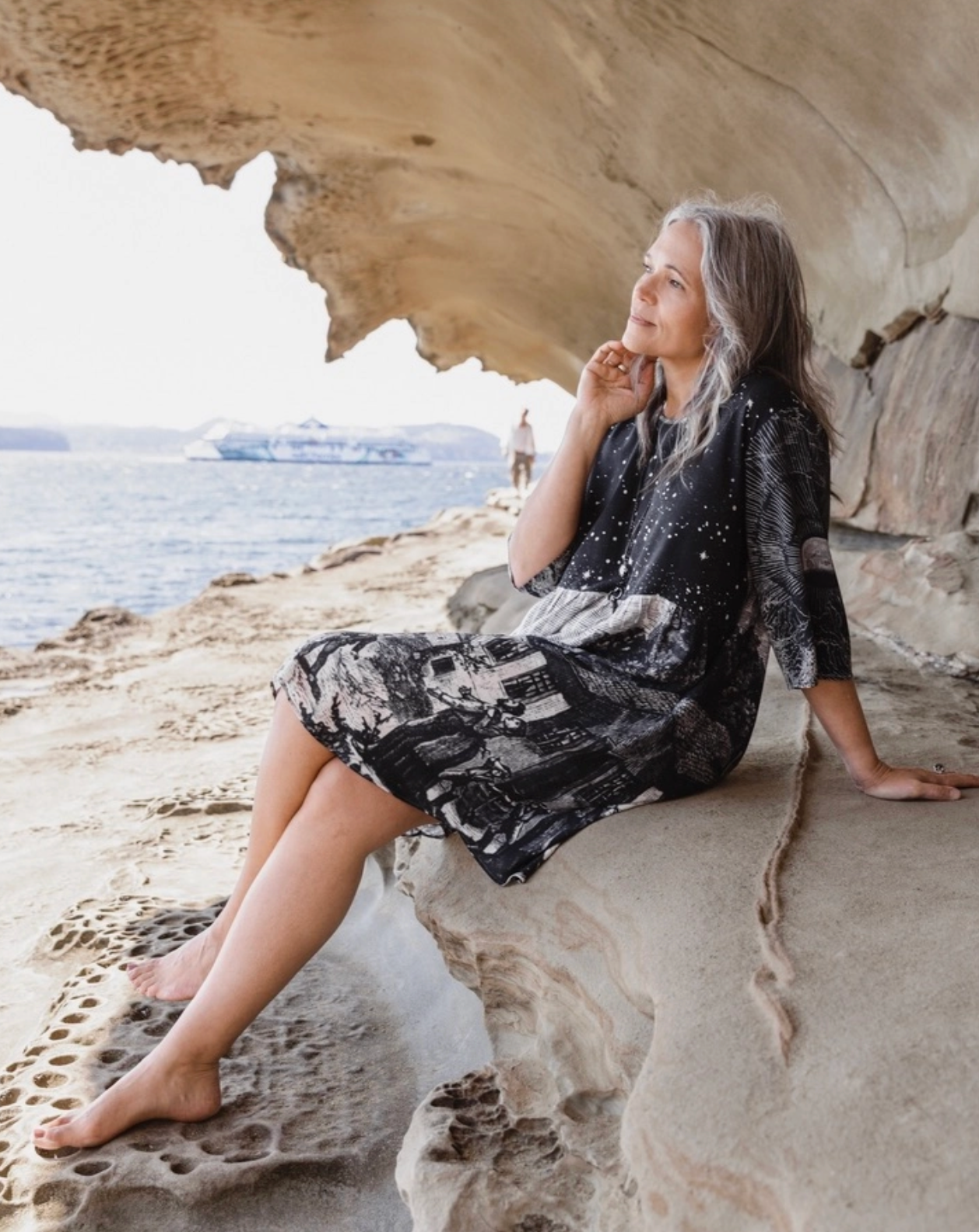 Full length front view of Stargazer Artist Dress styled with leggings in sandstone cave setting — boho-luxe celestial print dress | Bliss by Cori Boutique