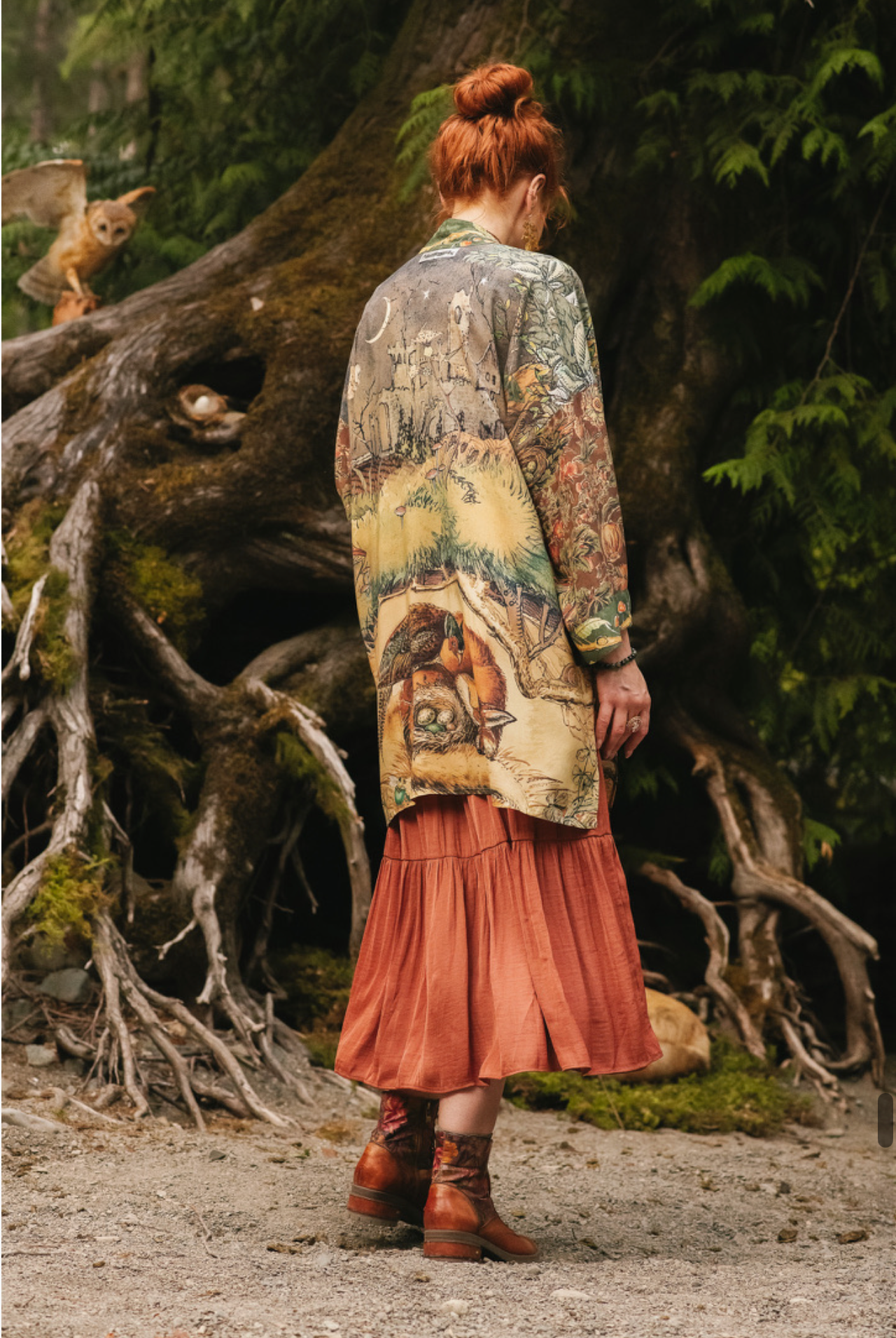 Woodland Wisdom Matinée Duster Kimono front view worn over rust tiered skirt, model standing by ancient tree roots with barn owls, enchanted forest setting — Bliss by Cori
