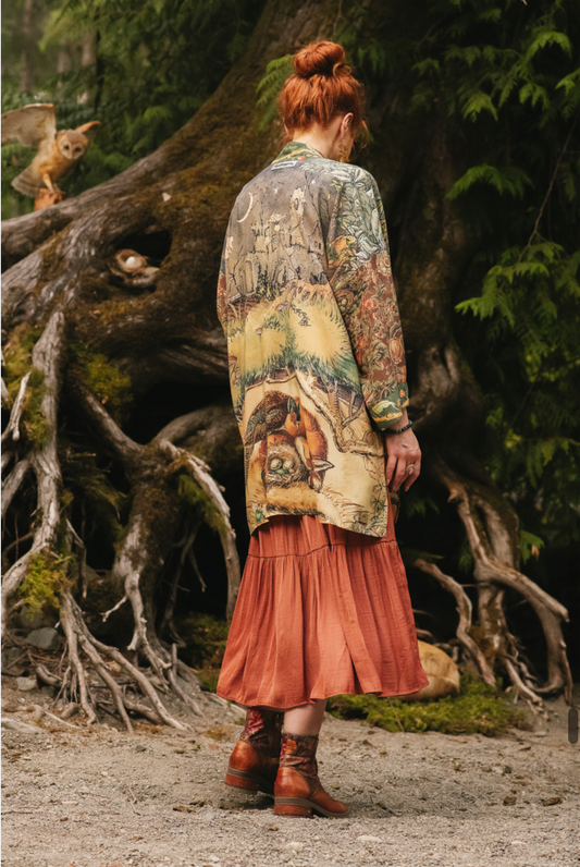 Woodland Wisdom Matinée Duster Kimono front view worn over rust tiered skirt, model standing by ancient tree roots with barn owls, enchanted forest setting — Bliss by Cori
