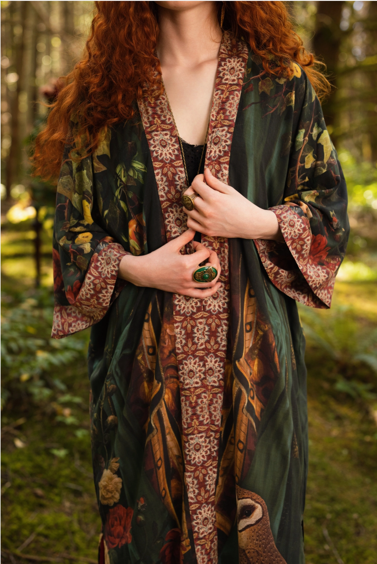 Detail of Solstice Opera Duster Kimono showing pomegranate and rose botanical print with tapestry border trim on dark green viscose — Bliss by Cori