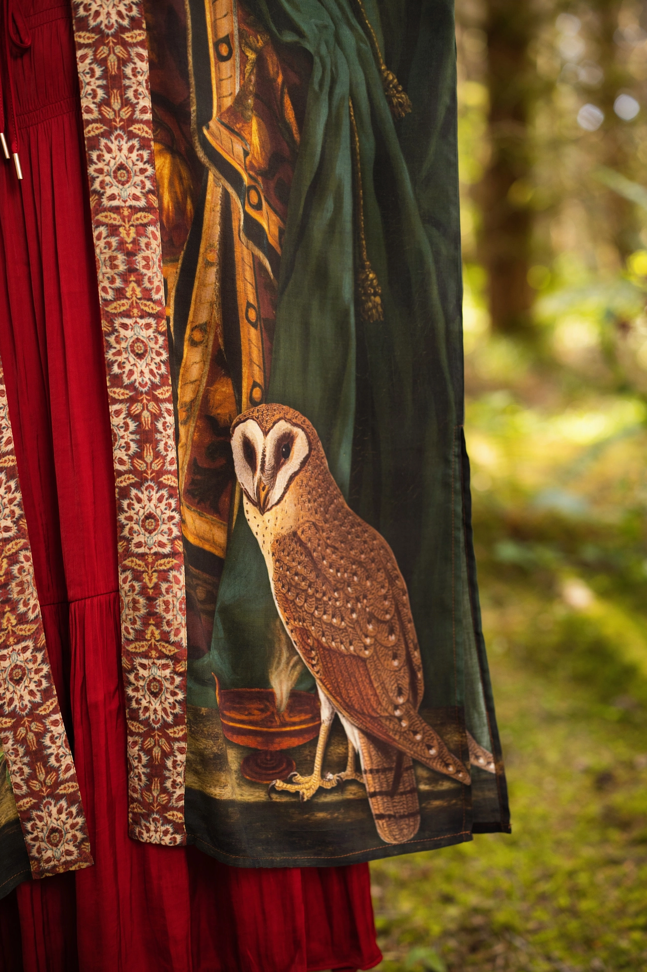 Detail of Solstice Opera Duster Kimono showing antique book, stars and Proserpine portrait print elements on deep green fabric with warm earthy tones — Bliss by Cori