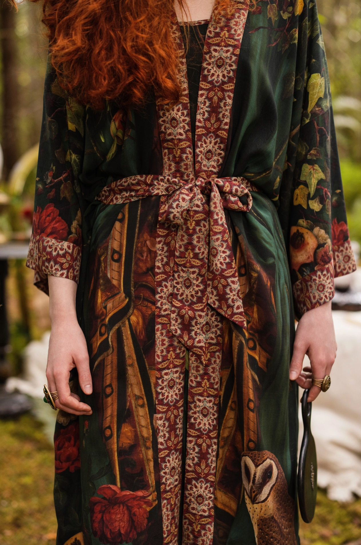 Close-up of Solstice Opera Duster Kimono showing ornate border trim and lower hem print with pomegranate, botanical and owl details — Bliss by Cori