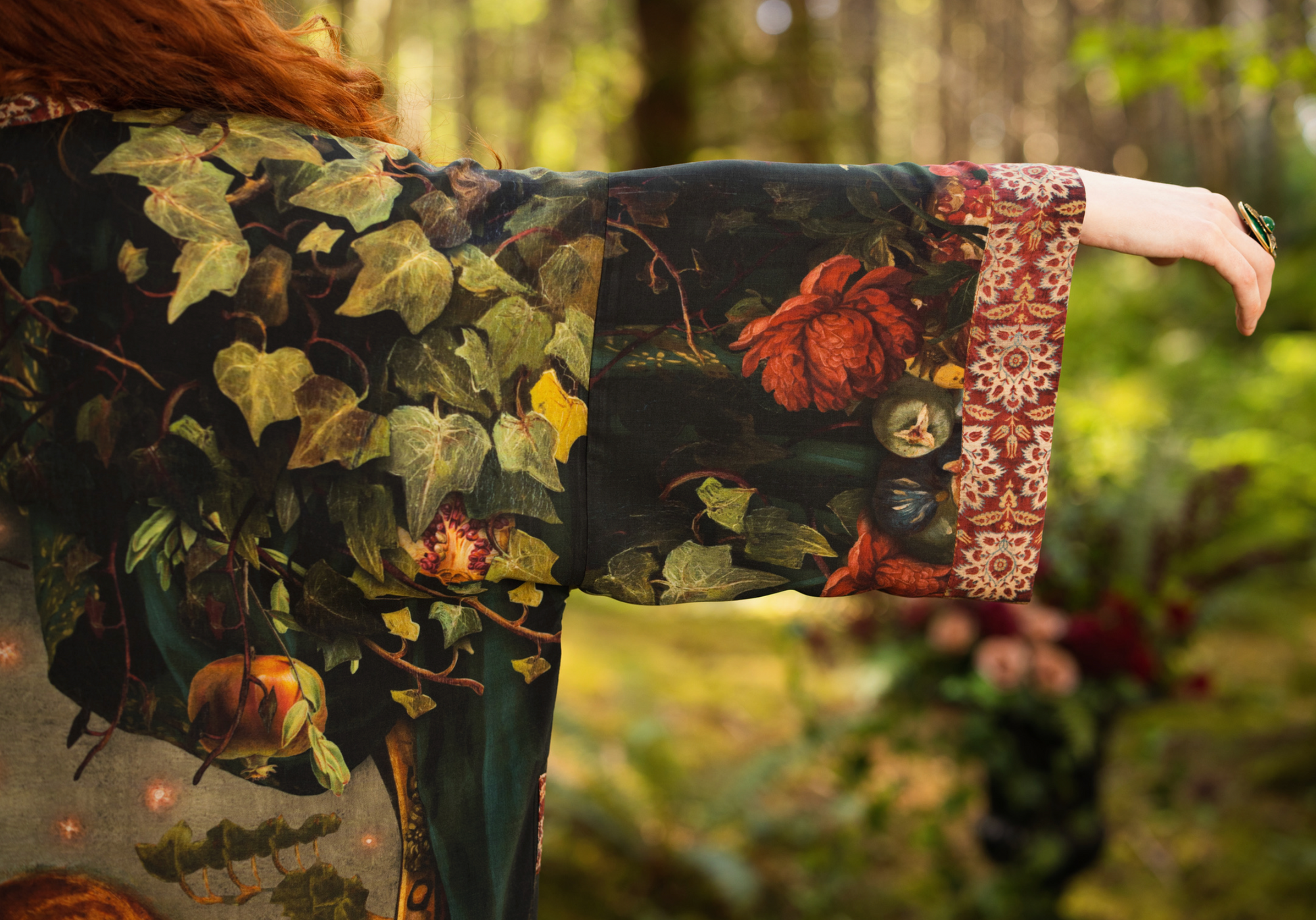Close-up of Solstice Opera Duster Kimono sleeve showing tapestry-inspired cuff trim and botanical ivy and floral print on dark viscose fabric — Bliss by Cori