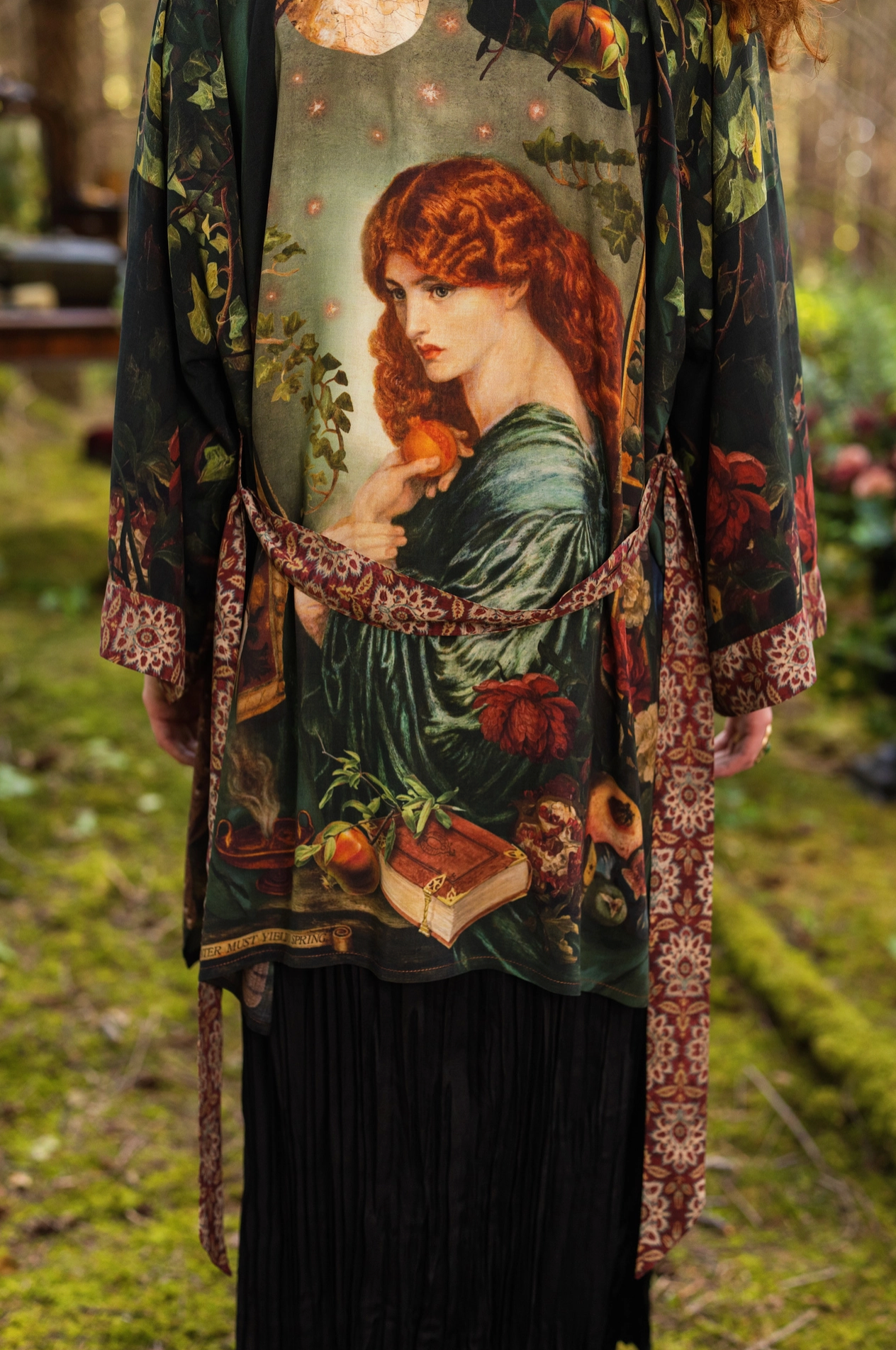 Close-up of Solstice Matinée Mid-Length Duster Kimono front panel showing owl and antique book print detail with warm tapestry border on dark green viscose — Bliss by Cori