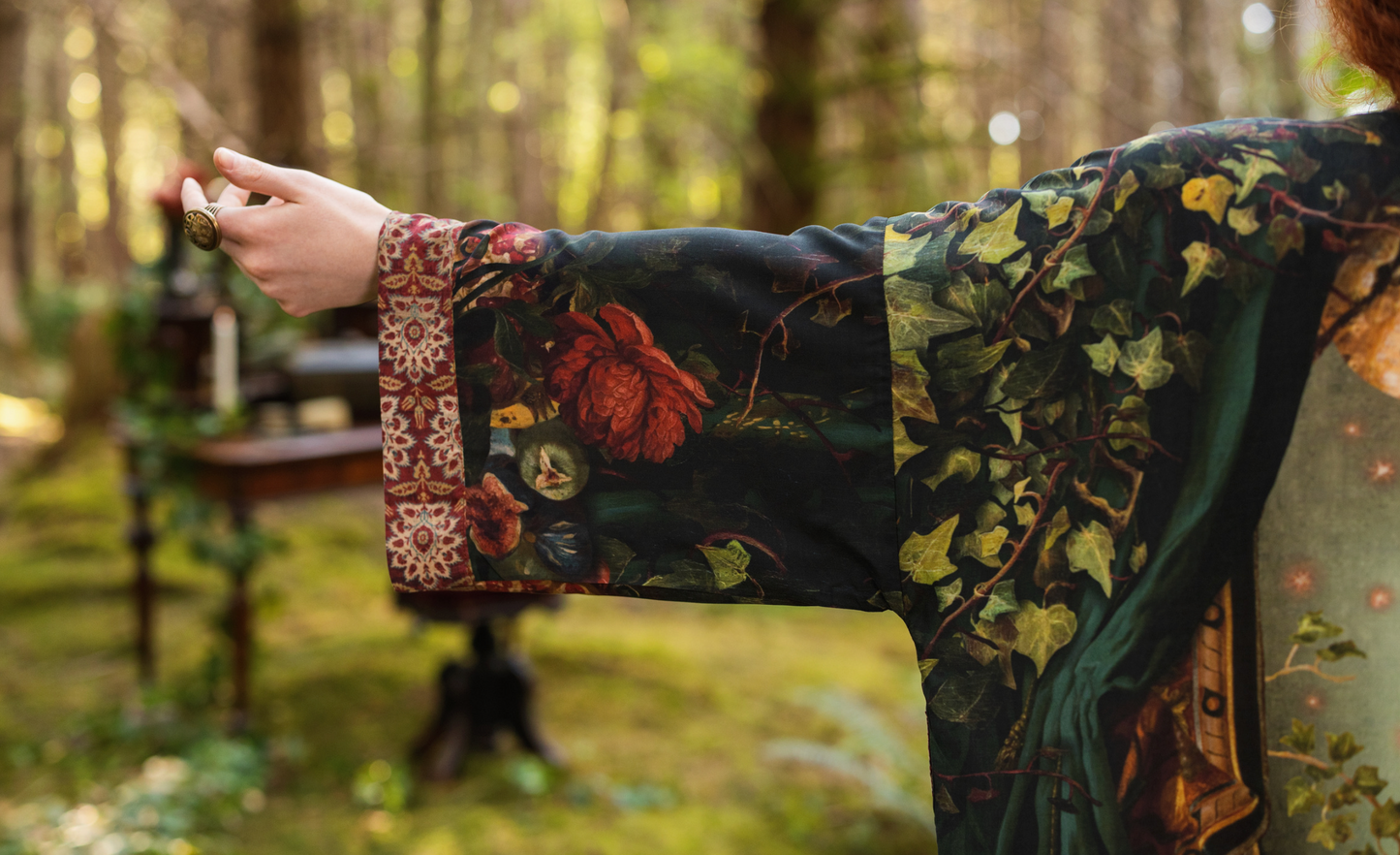 Detail shot of Solstice Matinée Mid-Length Duster Kimono showing full Rossetti Proserpine back print with roses, pomegranate, moon and ivy on deep green fabric — Bliss by Cori