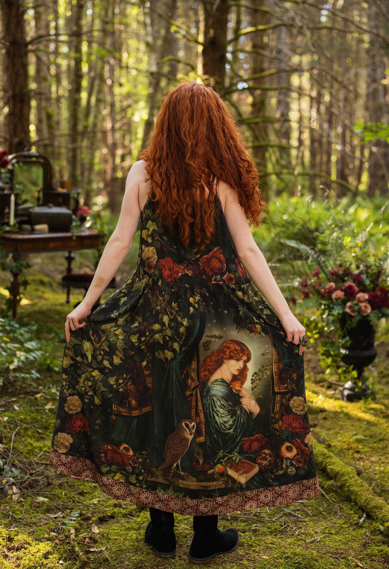 Detail of Solstice Bohéme Maxi Slip Dress showing Rossetti Proserpine portrait, pomegranate and rose print on deep forest green viscose fabric — Bliss by Cori
