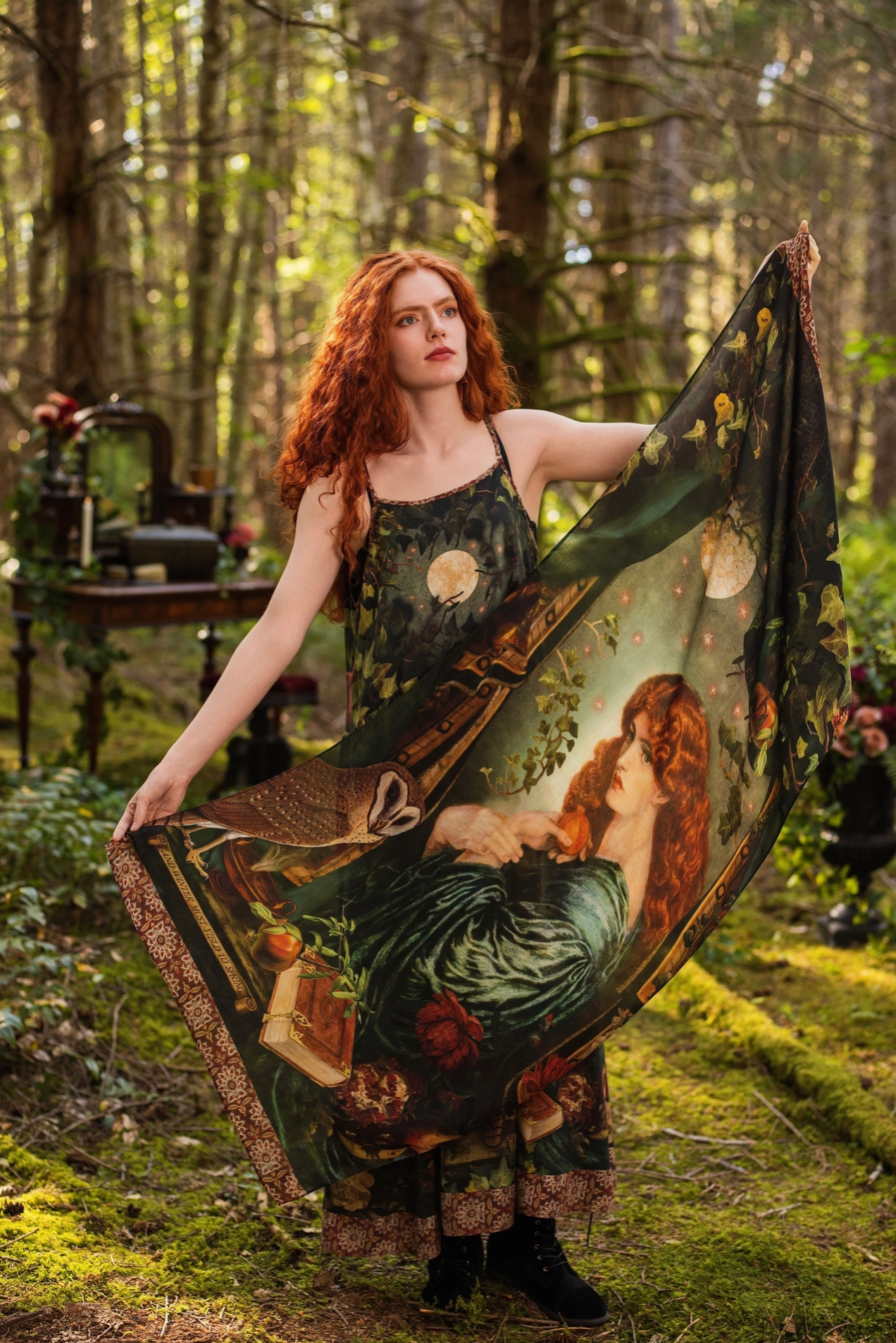 Close-up of Solstice Bohemian Scarf draped as a wrap showing Rossetti Proserpine portrait, barn owl, pomegranate, rose and ivy print on dark green viscose with warm terracotta tapestry border — Bliss by Cori
