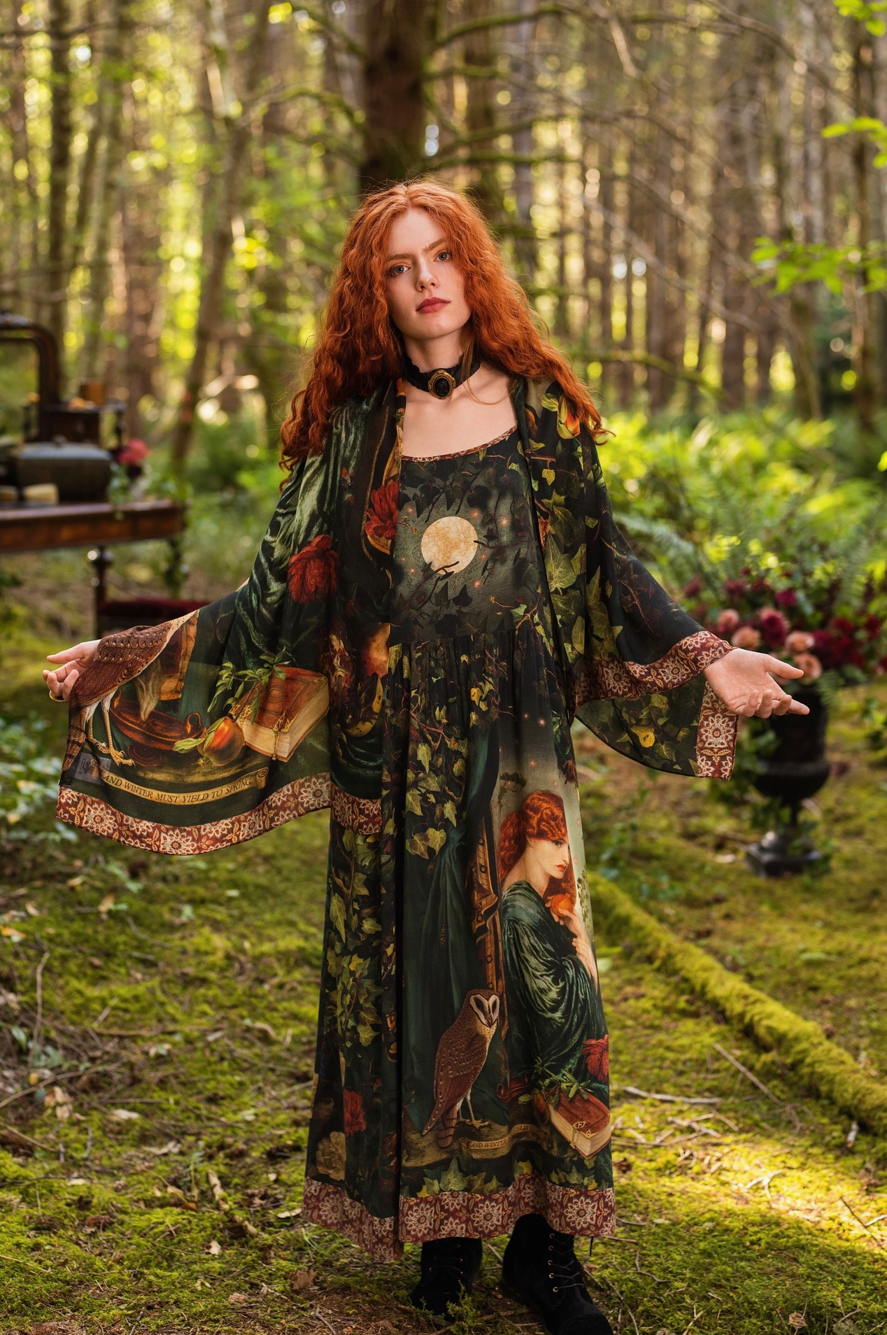 Red-haired model in mossy forest wearing Solstice Bohemian Scarf as a shawl over Solstice Maxi Slip Dress with arms outstretched, full moon, Proserpine portrait, barn owl and tapestry border visible, antique dresser and flowers behind — Bliss by Cori