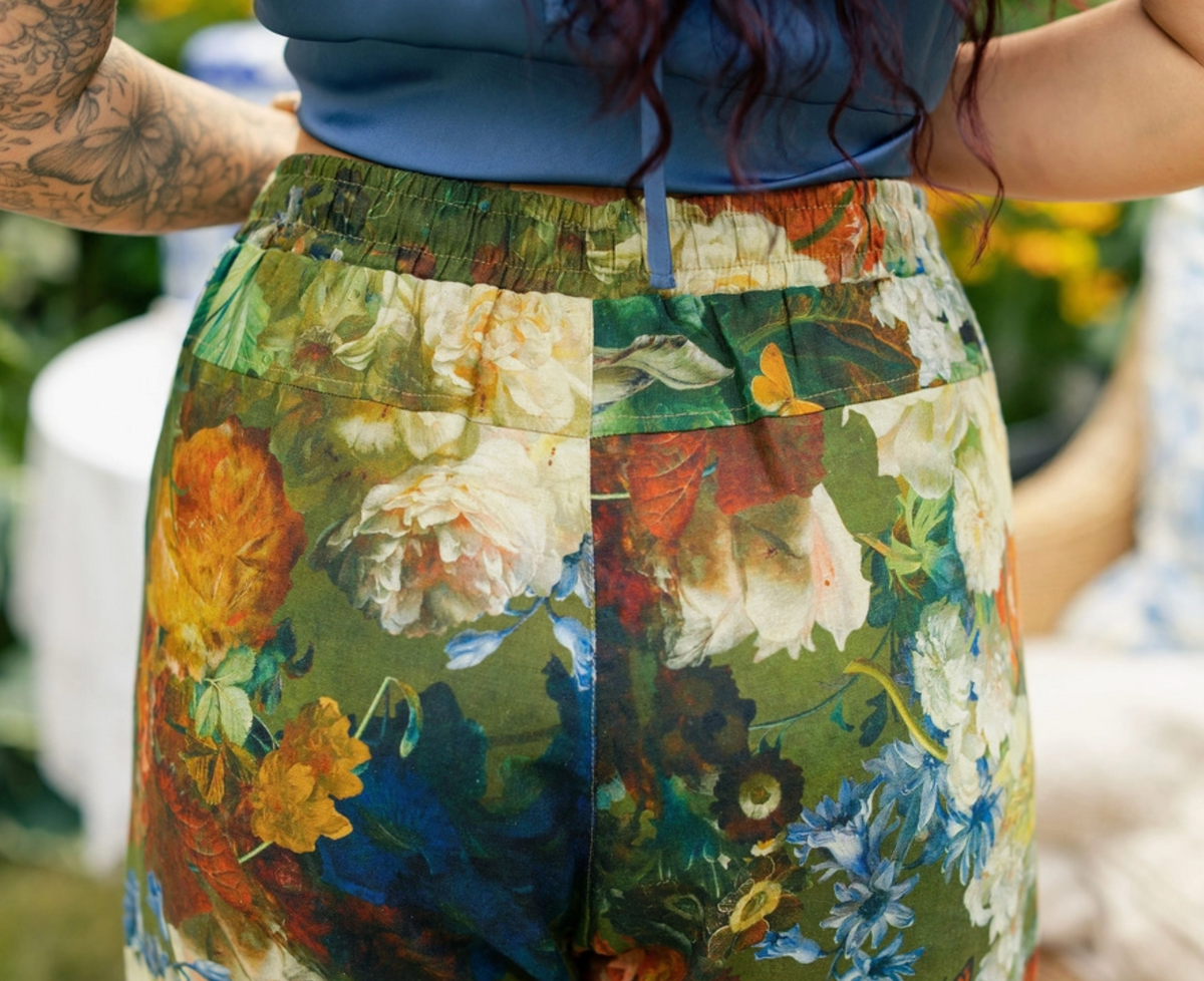 Close-up of the botanical flowers and birds on Flora Poetica artist pants | Bliss by Cori
