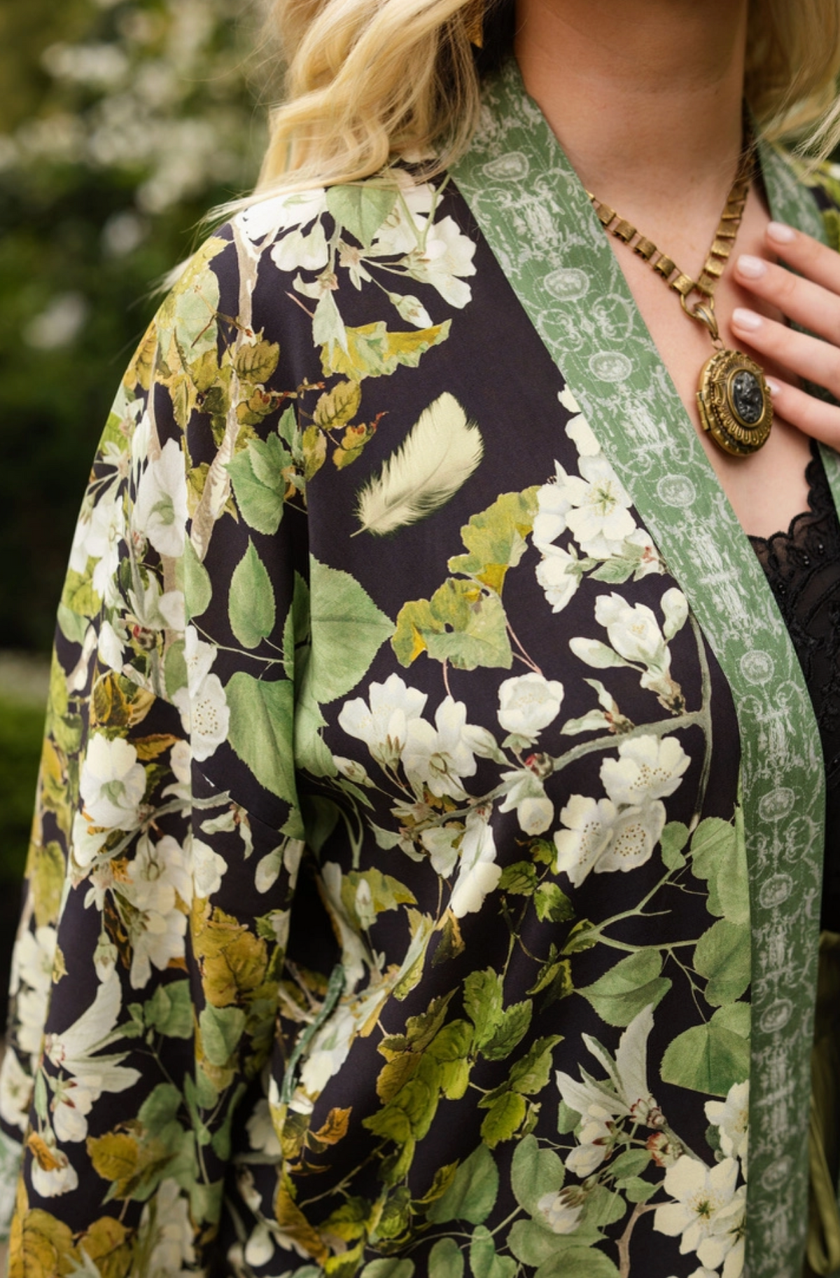 Close-up of the Equinox duster sleeve with white blossoms, green leaves and dark botanical print | Bliss by Cori