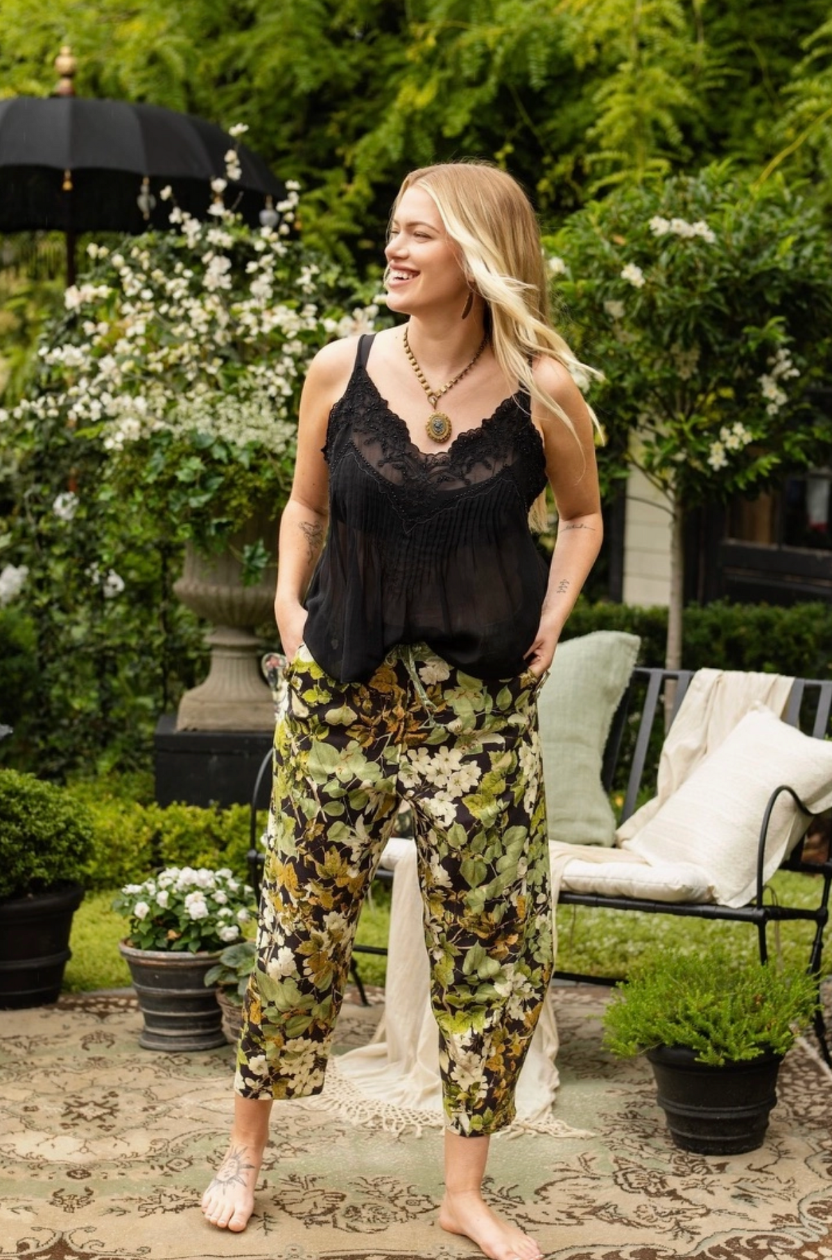 Front garden view of a model wearing the Equinox botanical cropped Artist Pants | Bliss by Cori
