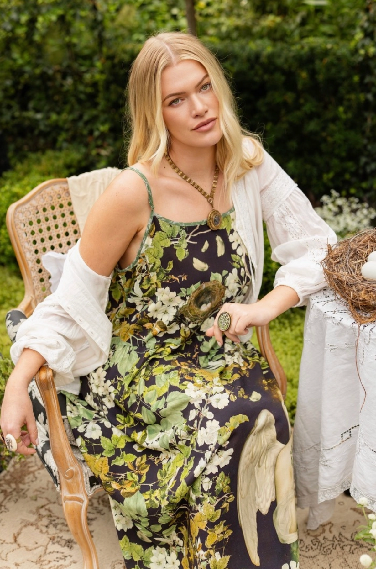 Seated model showing the neckline and flowing fit of the Equinox maxi slip dress | Bliss by Cori