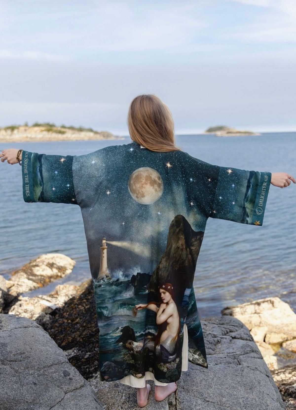 Rear view with arms extended to display the full width and celestial artwork of the Siren duster | Bliss by Cori