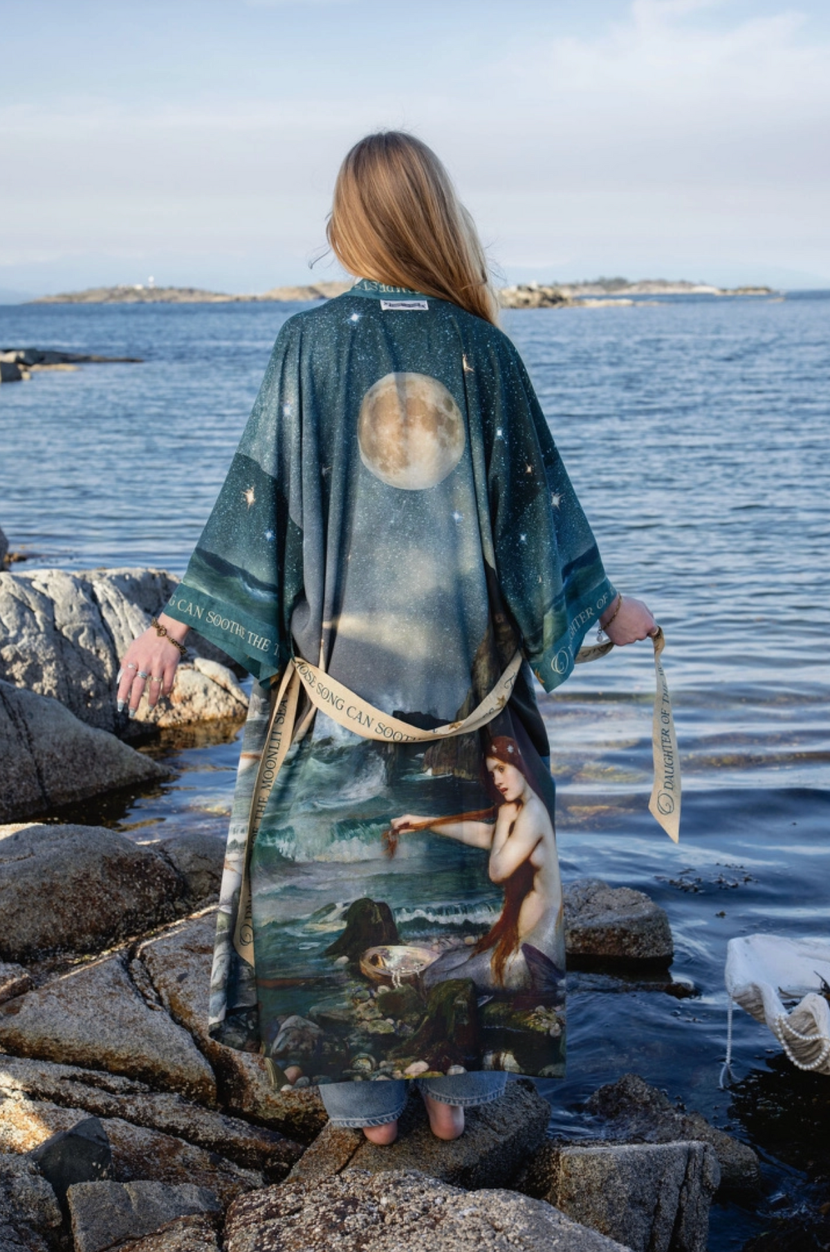 Back view of the Market of Stars Siren opera duster with moon and mermaid artwork beside the sea | Bliss by Cori