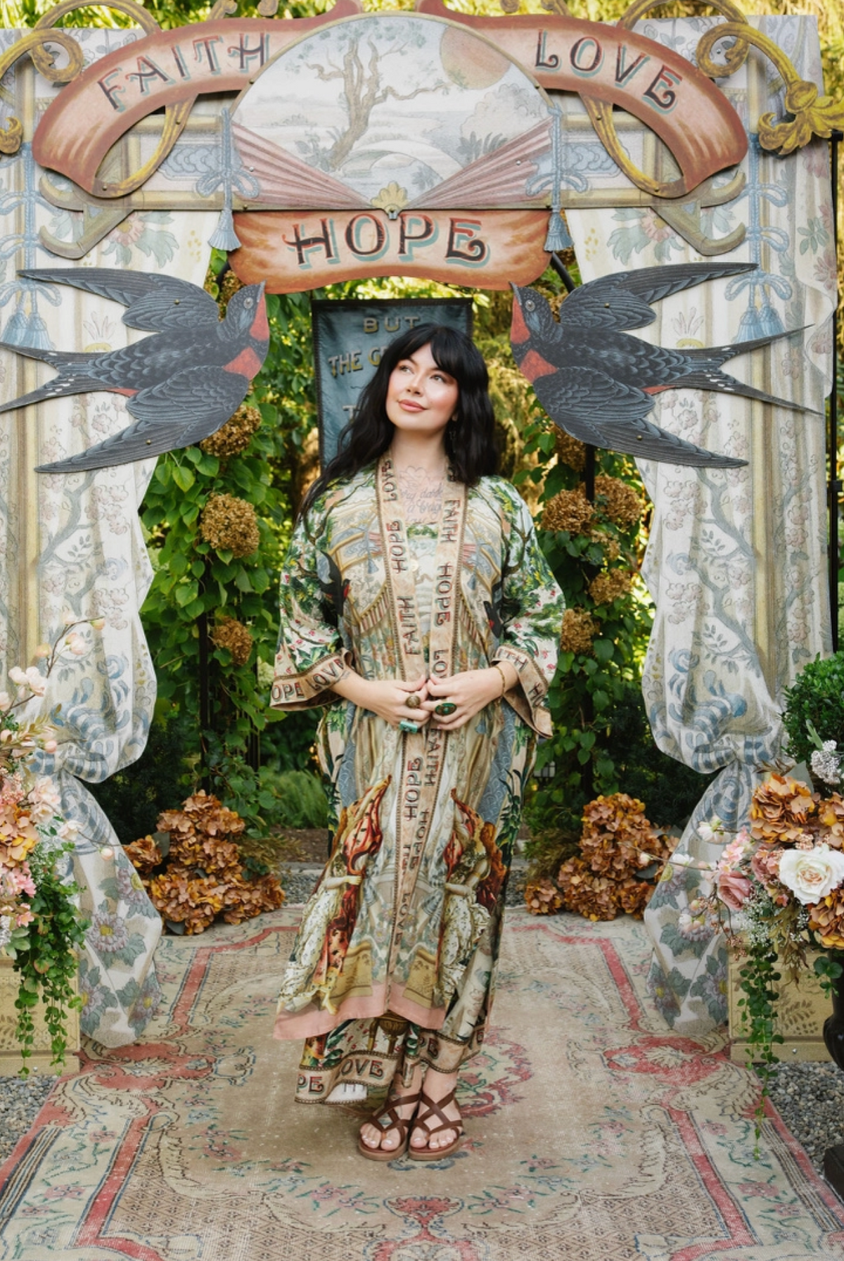 Front view of Book of Love opera duster layered over a coordinating printed outfit in a garden | Bliss by Cori