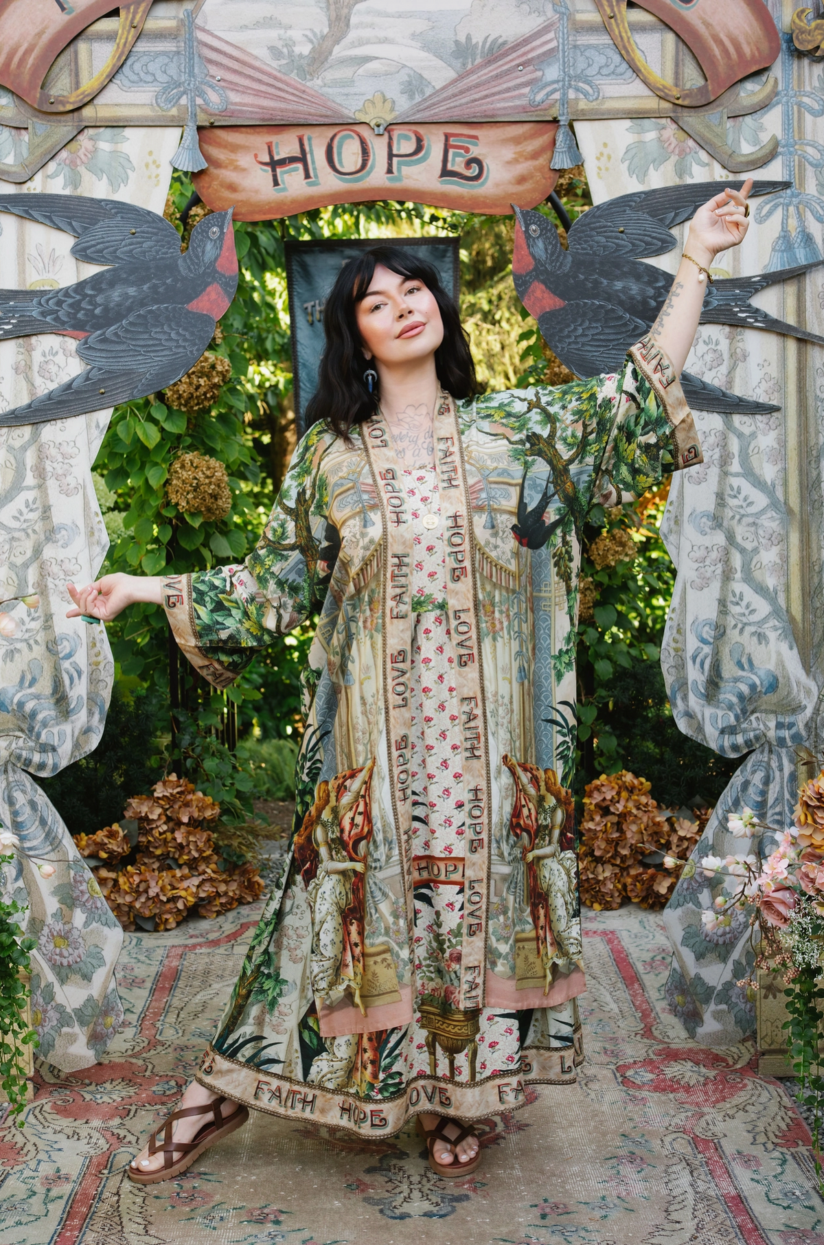 Model wearing Book of Love opera duster over a coordinating printed outfit, arms extended | Bliss by Cori