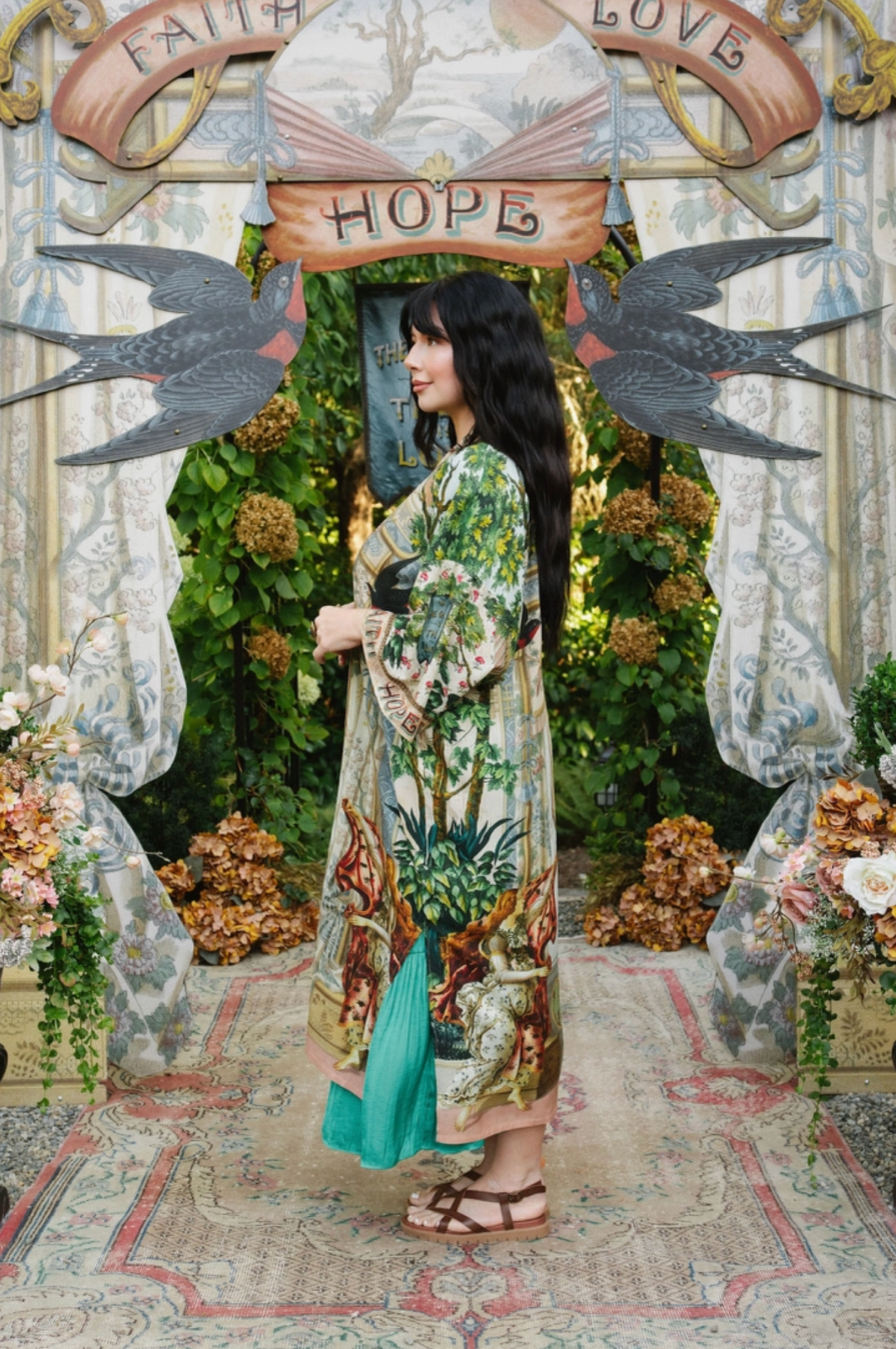 Side view of Book of Love opera duster over a turquoise dress, showing wide sleeves and illustrated hem | Bliss by Cori