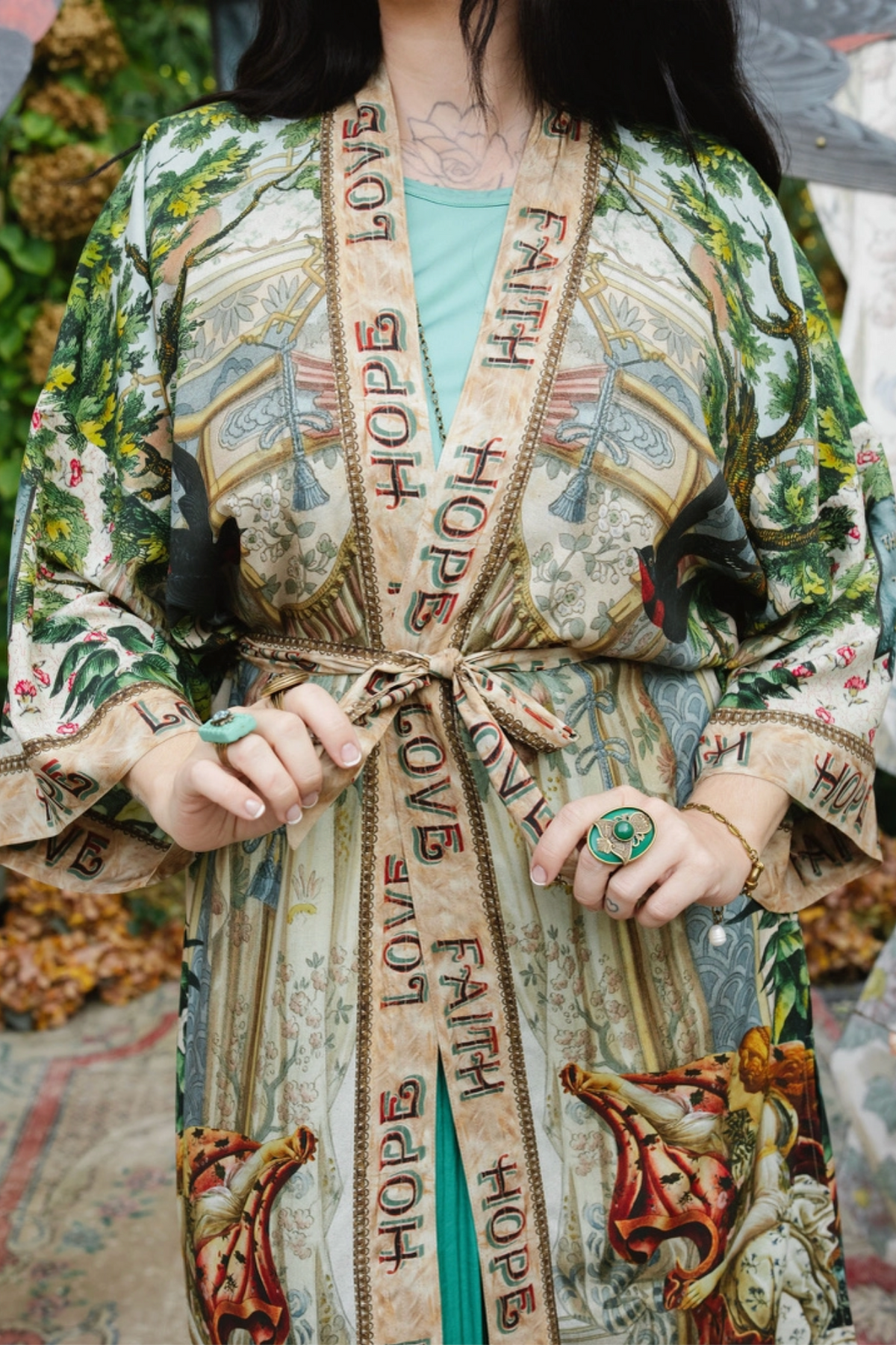 Close-up of Book of Love duster with its matching belt tied at the waist and Faith Hope Love front trim | Bliss by Cori