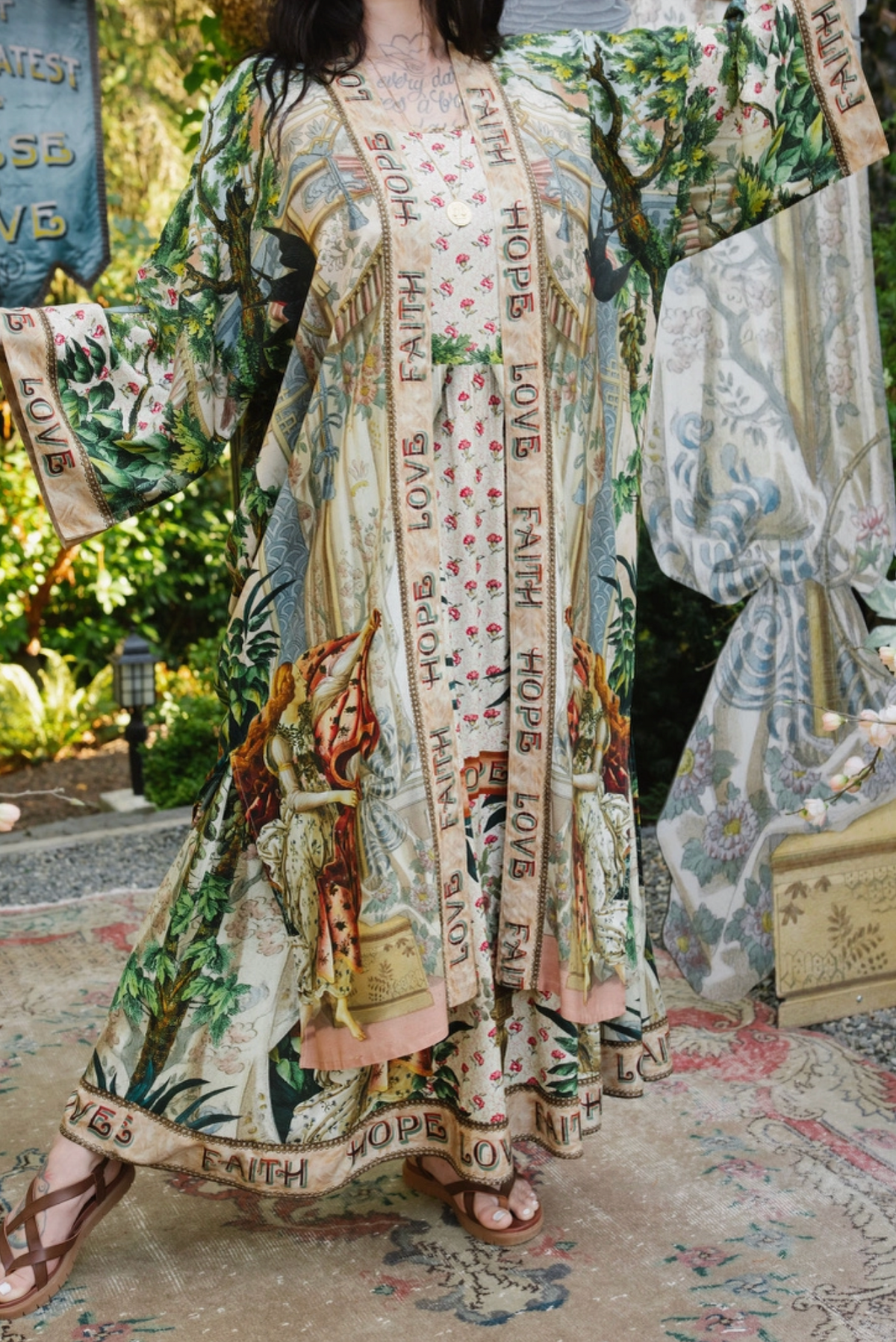 Book of Love duster worn open over a matching printed outfit, showing illustrated panels and pink hem | Bliss by Cori