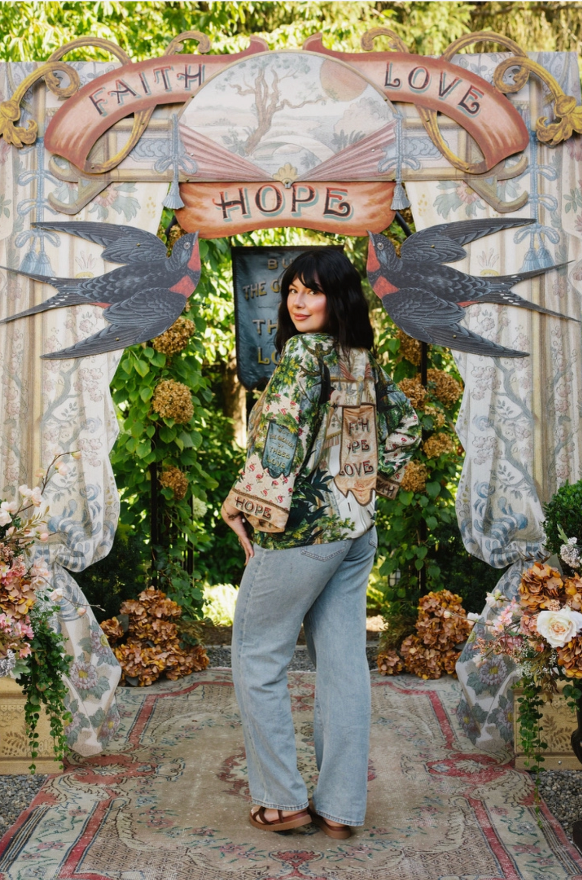 Model looking over her shoulder in Book of Love cropped kimono and jeans, showing the Faith Hope Love back banner | Bliss by Cori