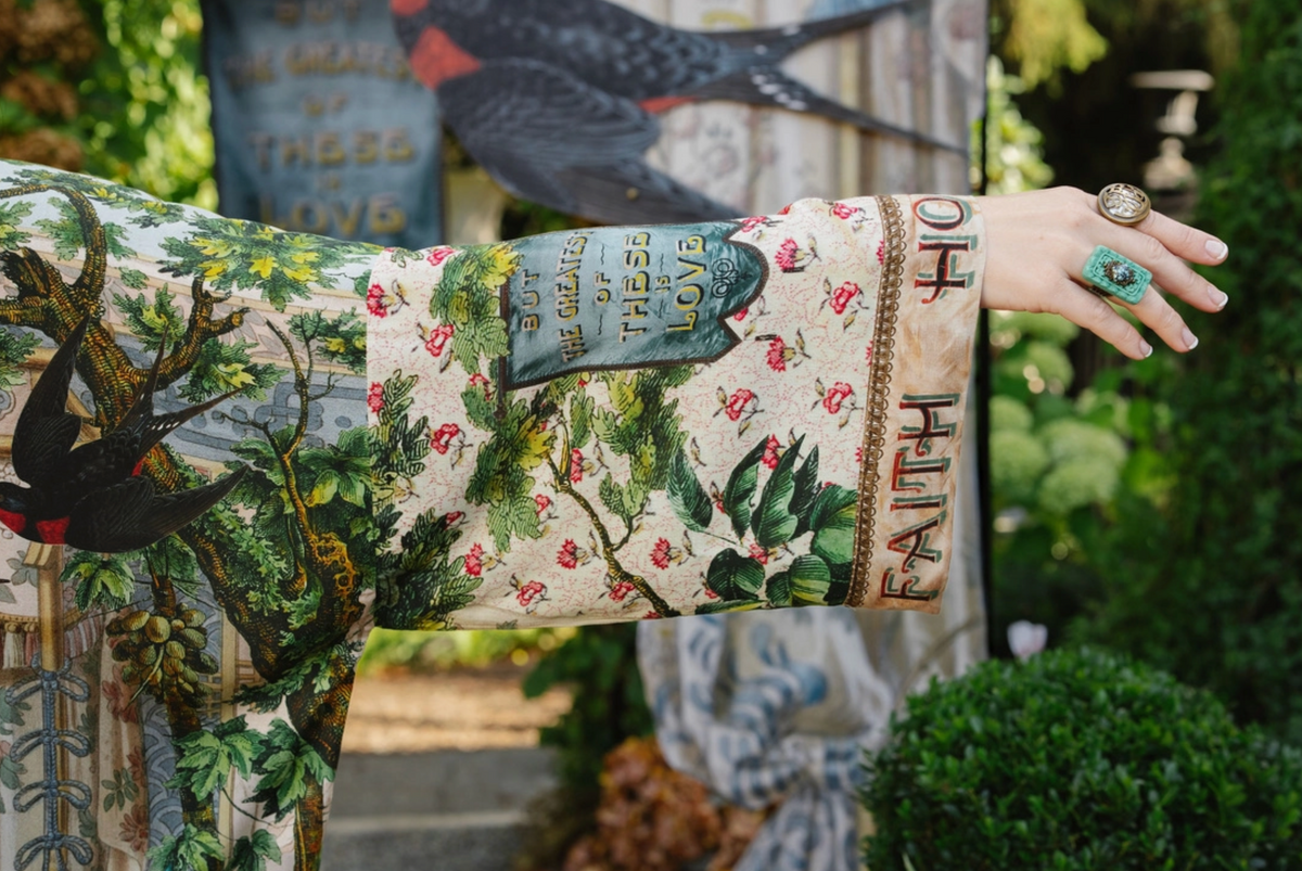 Book of Love kimono sleeve detail showing pink flowers, a blue love banner, and lettered cuff | Bliss by Cori