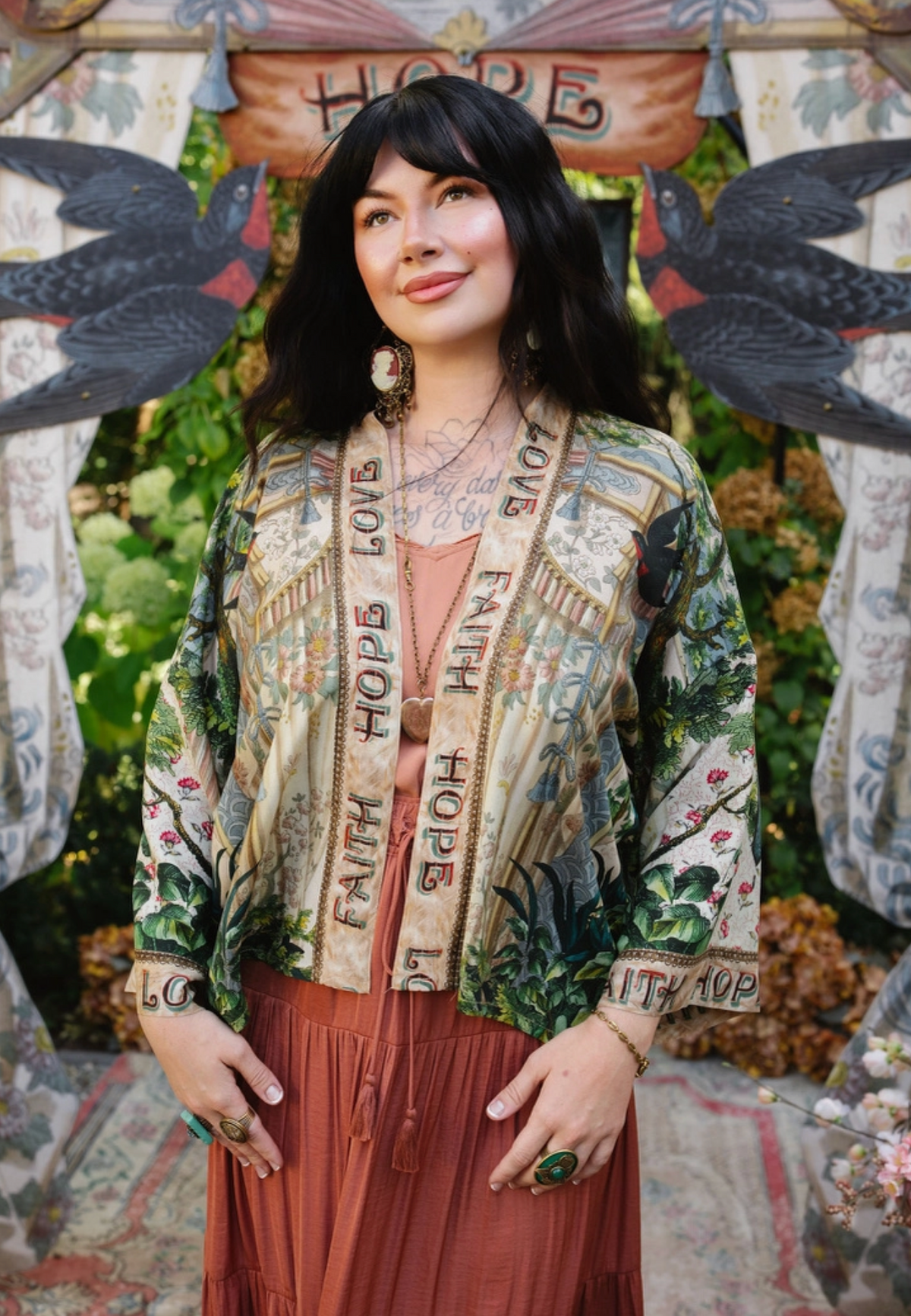 Front view of Book of Love cropped kimono over a coral dress, showing illustrated panels and lettered trim | Bliss by Cori