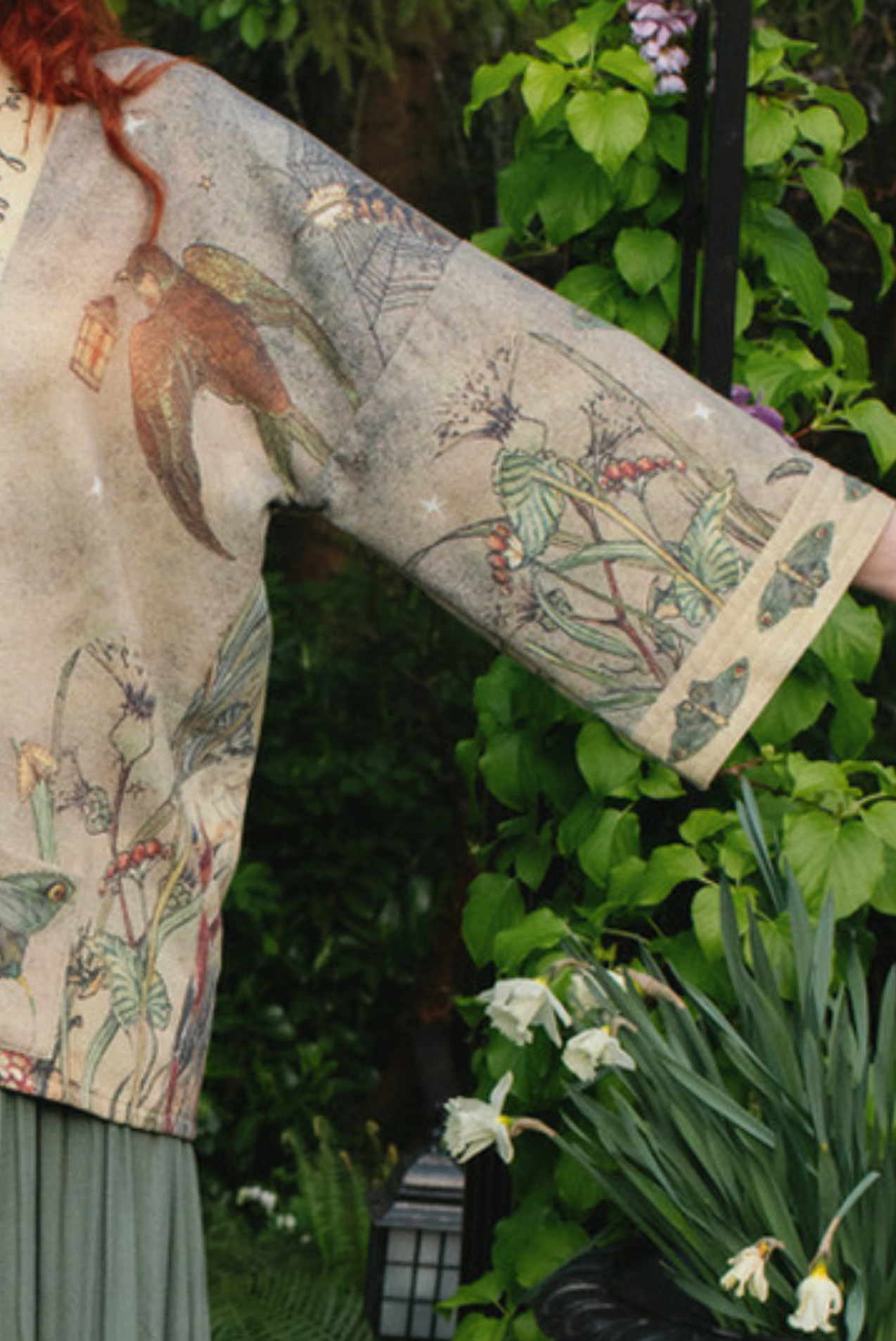 Full length view of Lovelight Cottage Jacket worn under wisteria garden arch with owls | Bliss by Cori