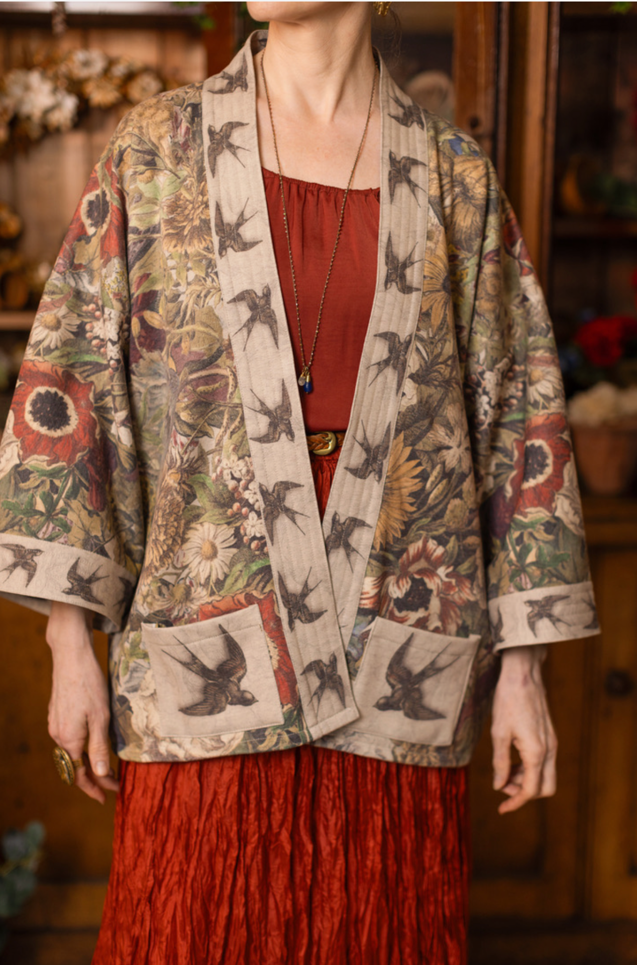Model wearing Golden Hour Cottage Jacket arms crossed in antique flower shop | Bliss by Cori