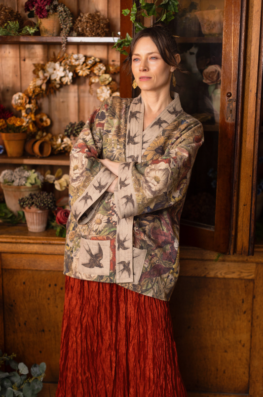 Model wearing Golden Hour Cottage Jacket in warm candlelit botanical interior | Bliss by Cori"