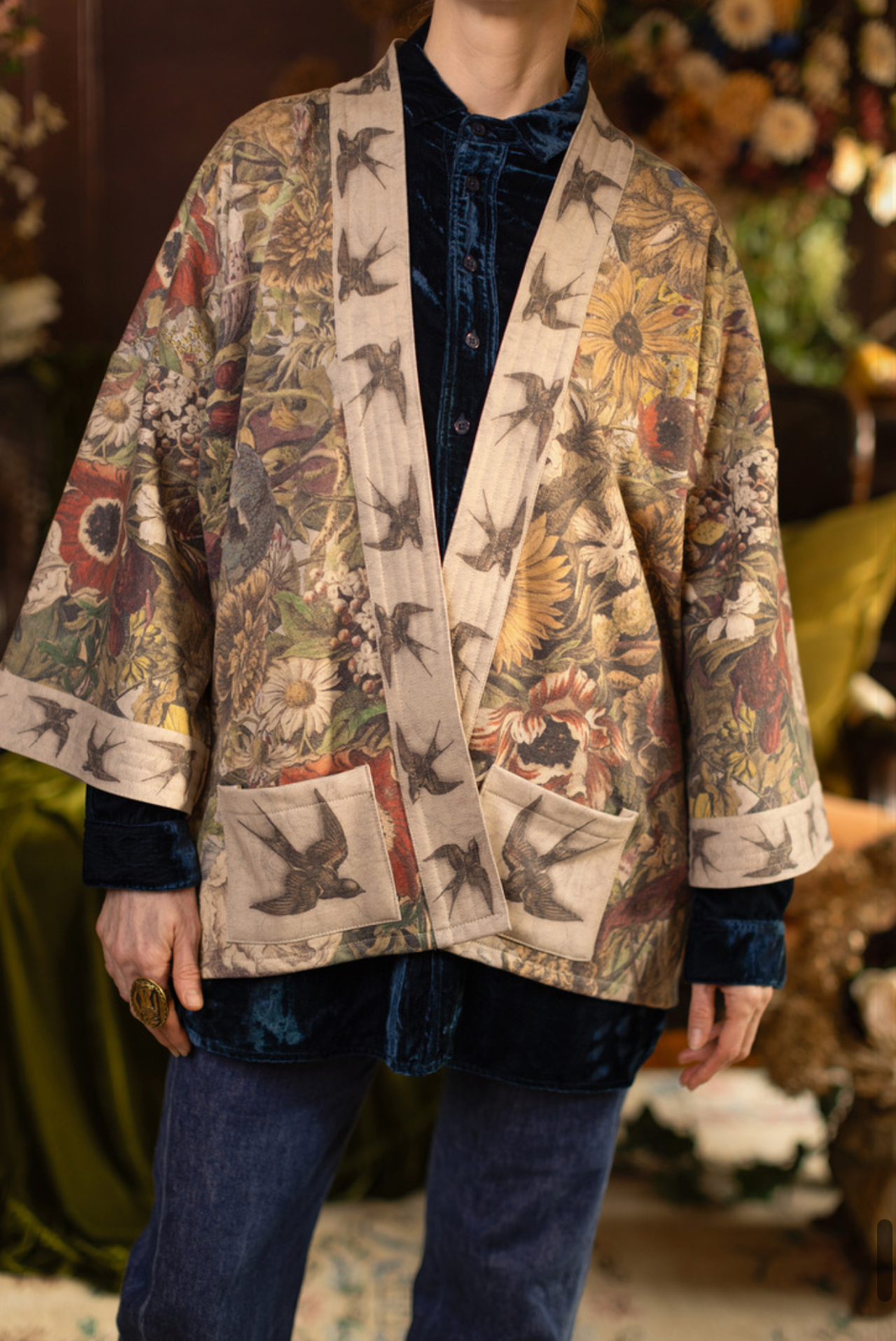 Model wearing Golden Hour Cottage Jacket in warm candlelit botanical interior | Bliss by Cori